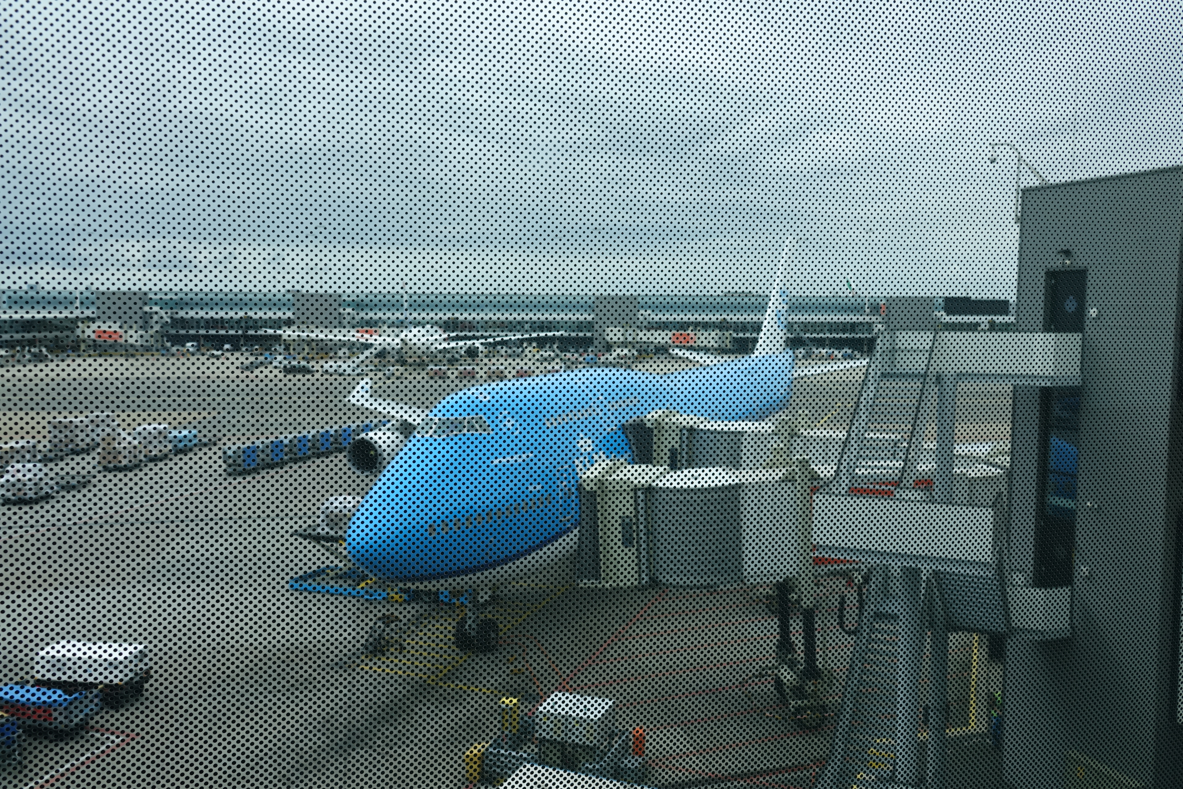 a blue airplane at an airport