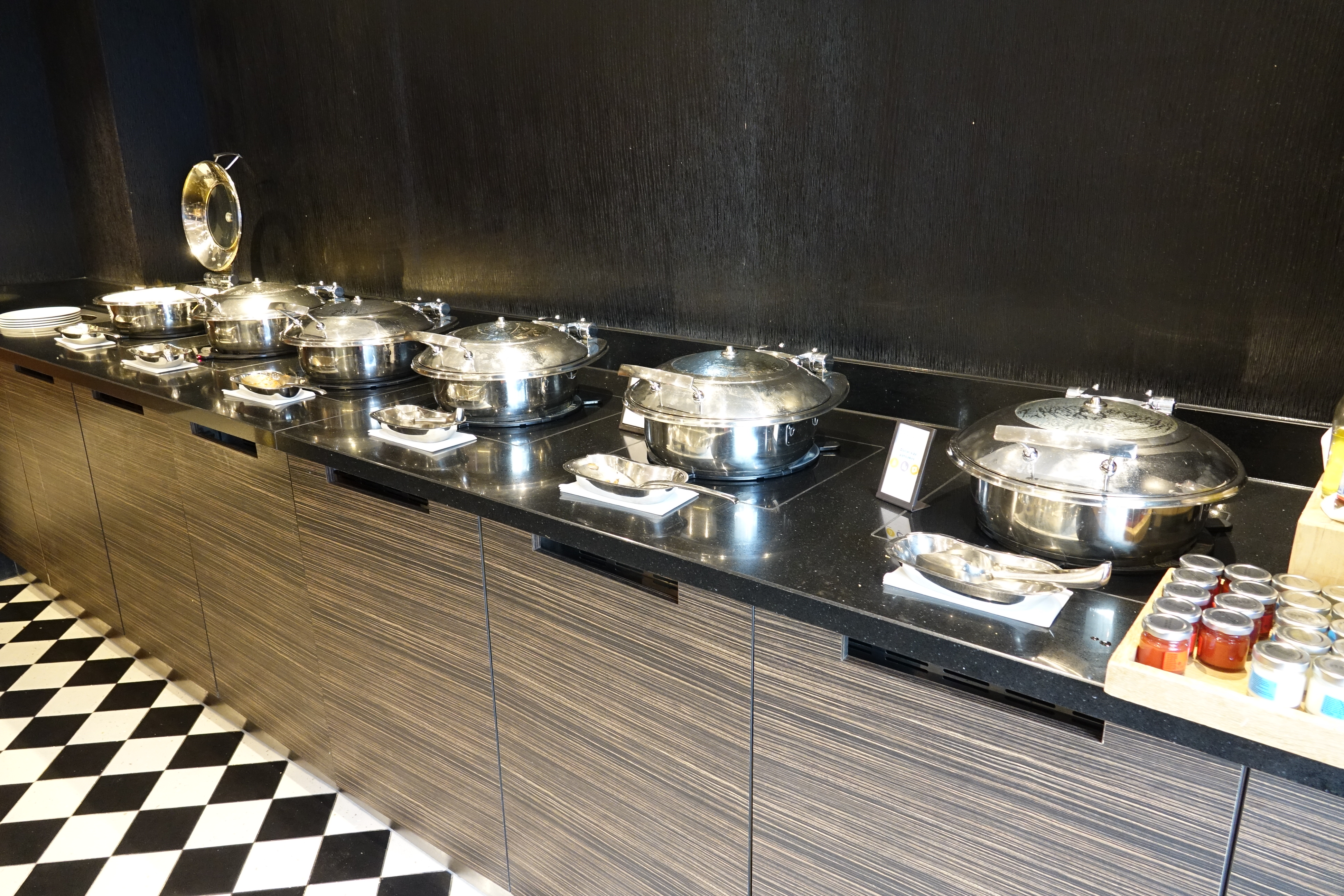 a row of silver pots on a counter