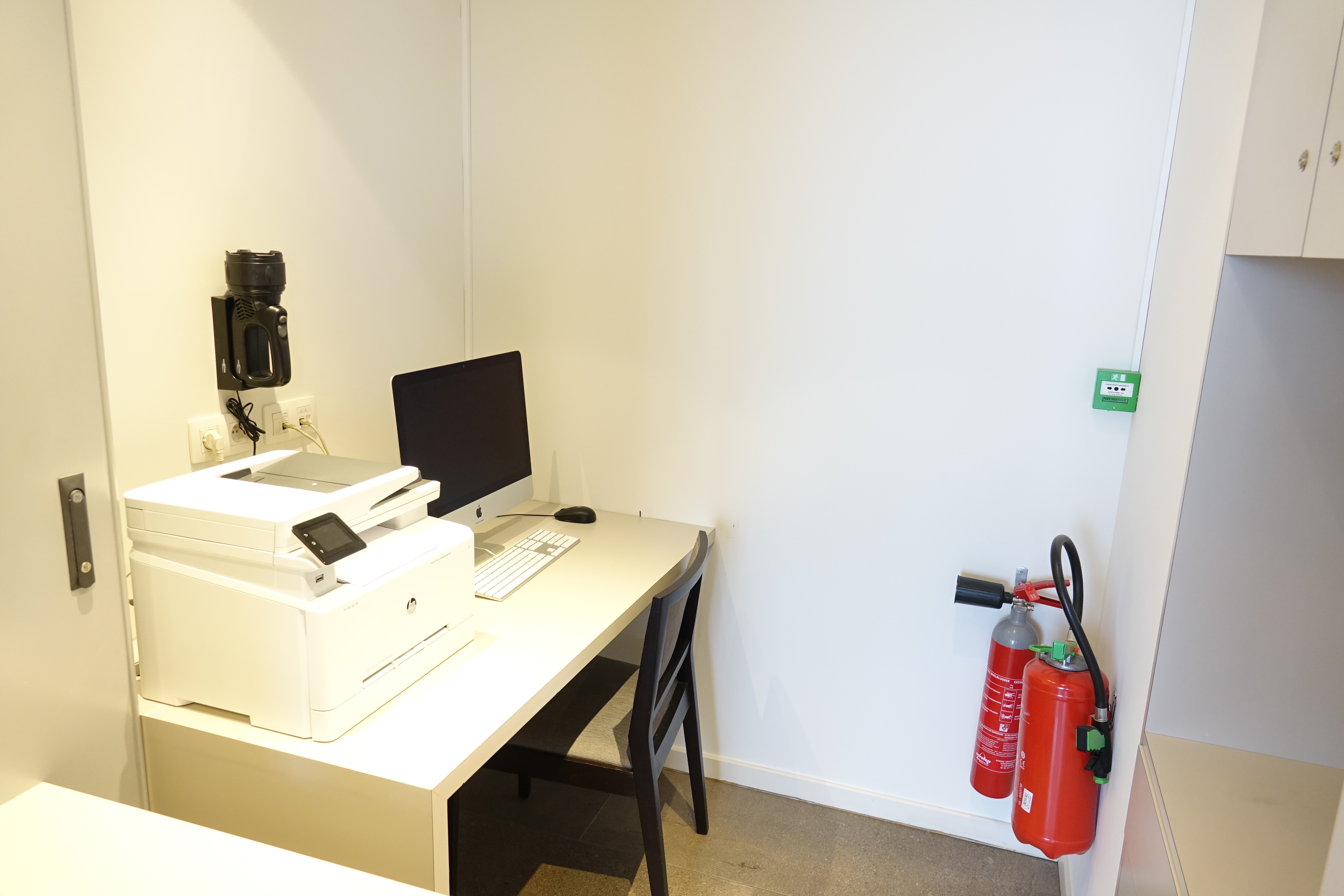 a desk with a computer and a printer