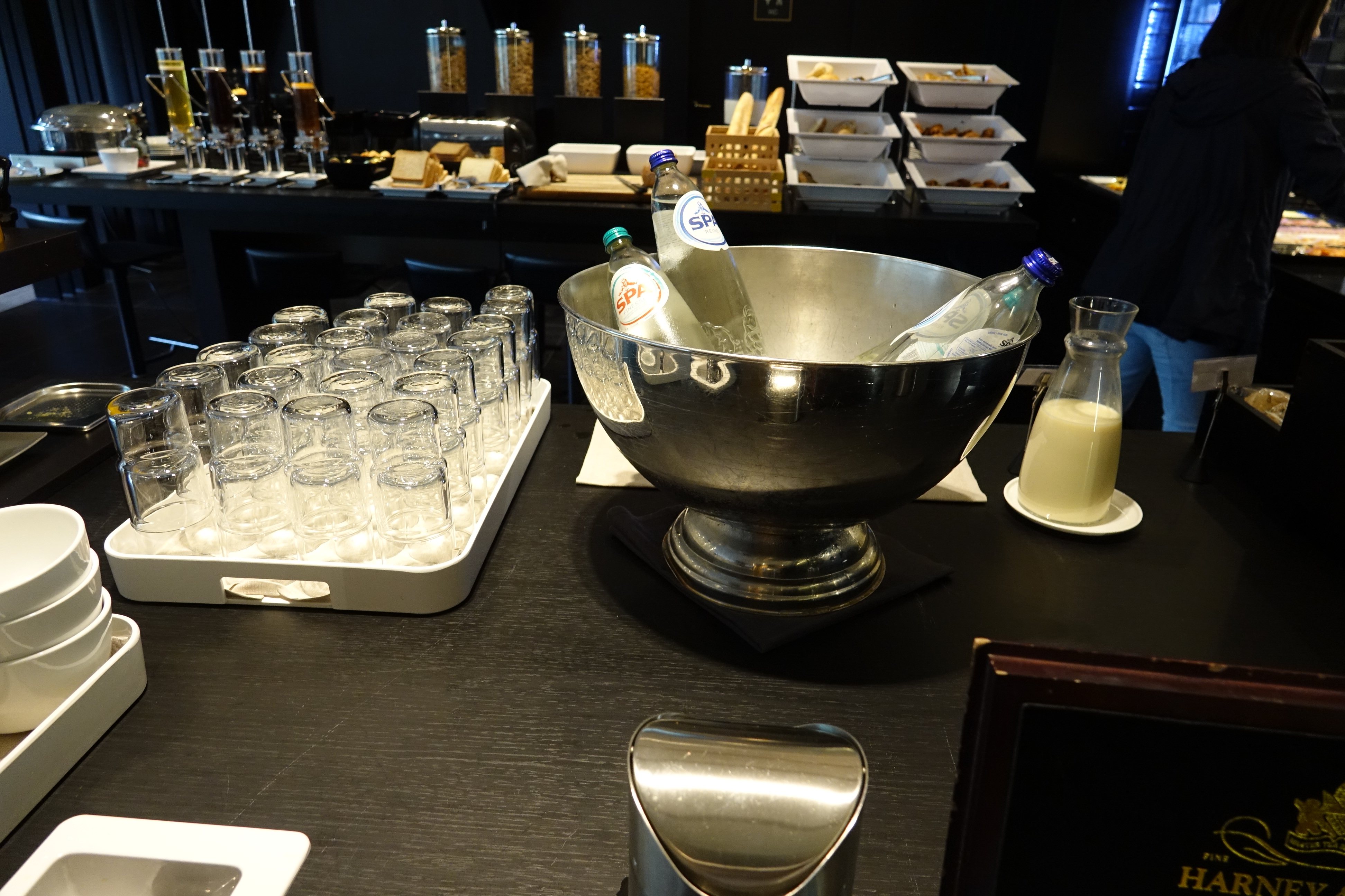 a bowl of bottles and glasses on a table