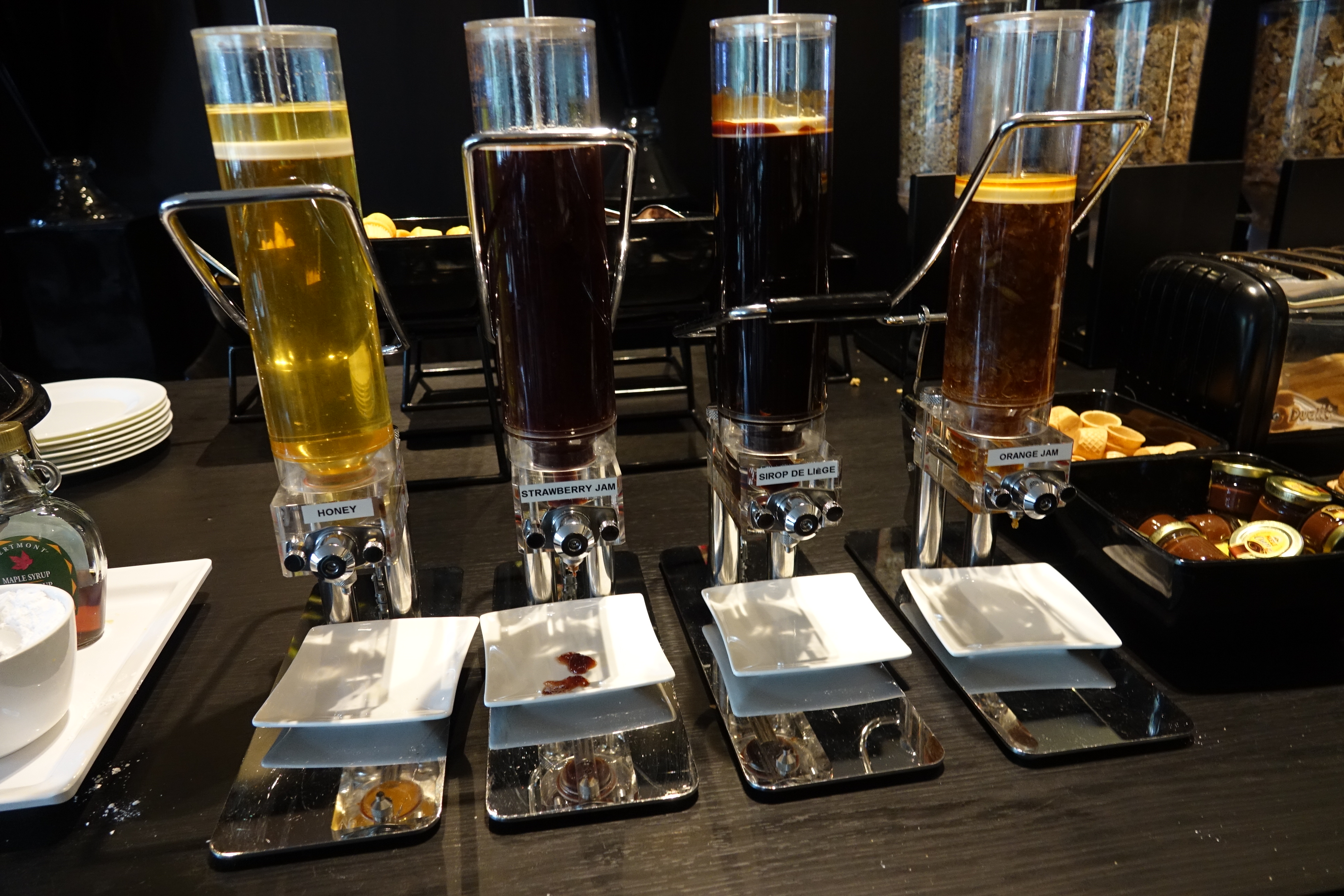 a group of liquid dispensers on a table