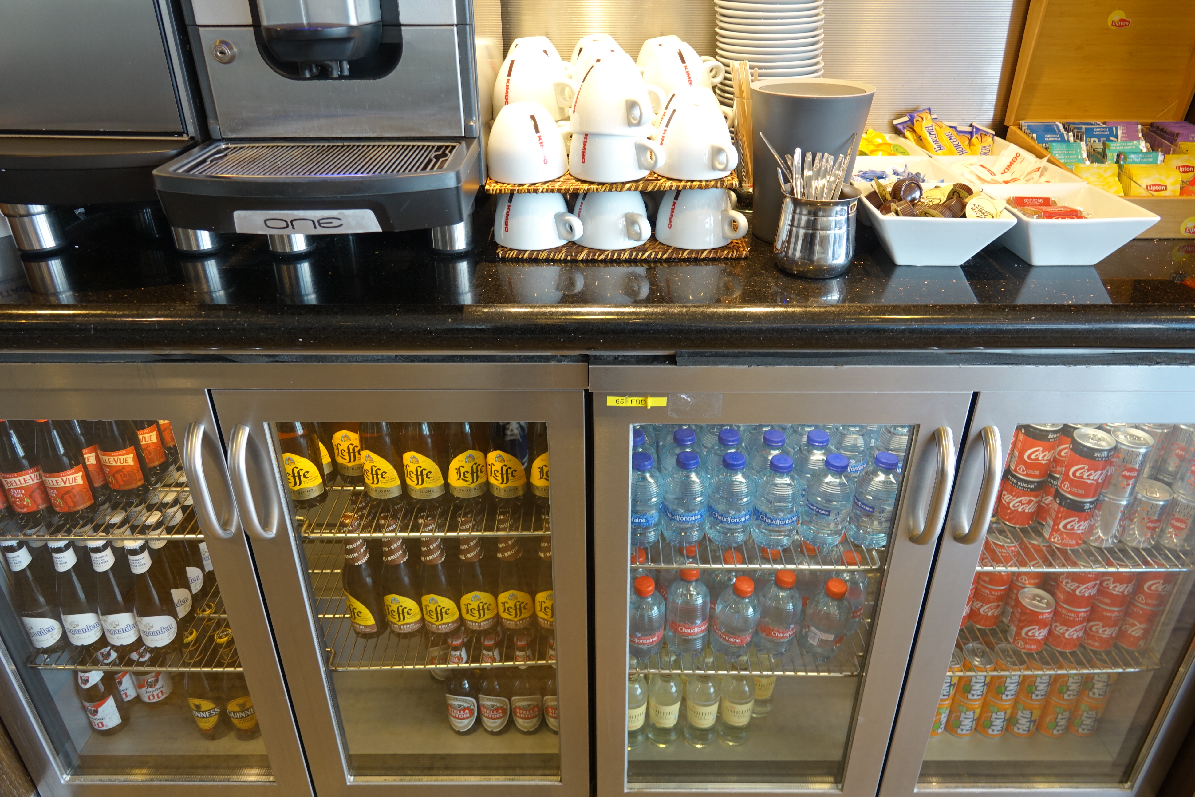 a coffee machine and cups on a counter