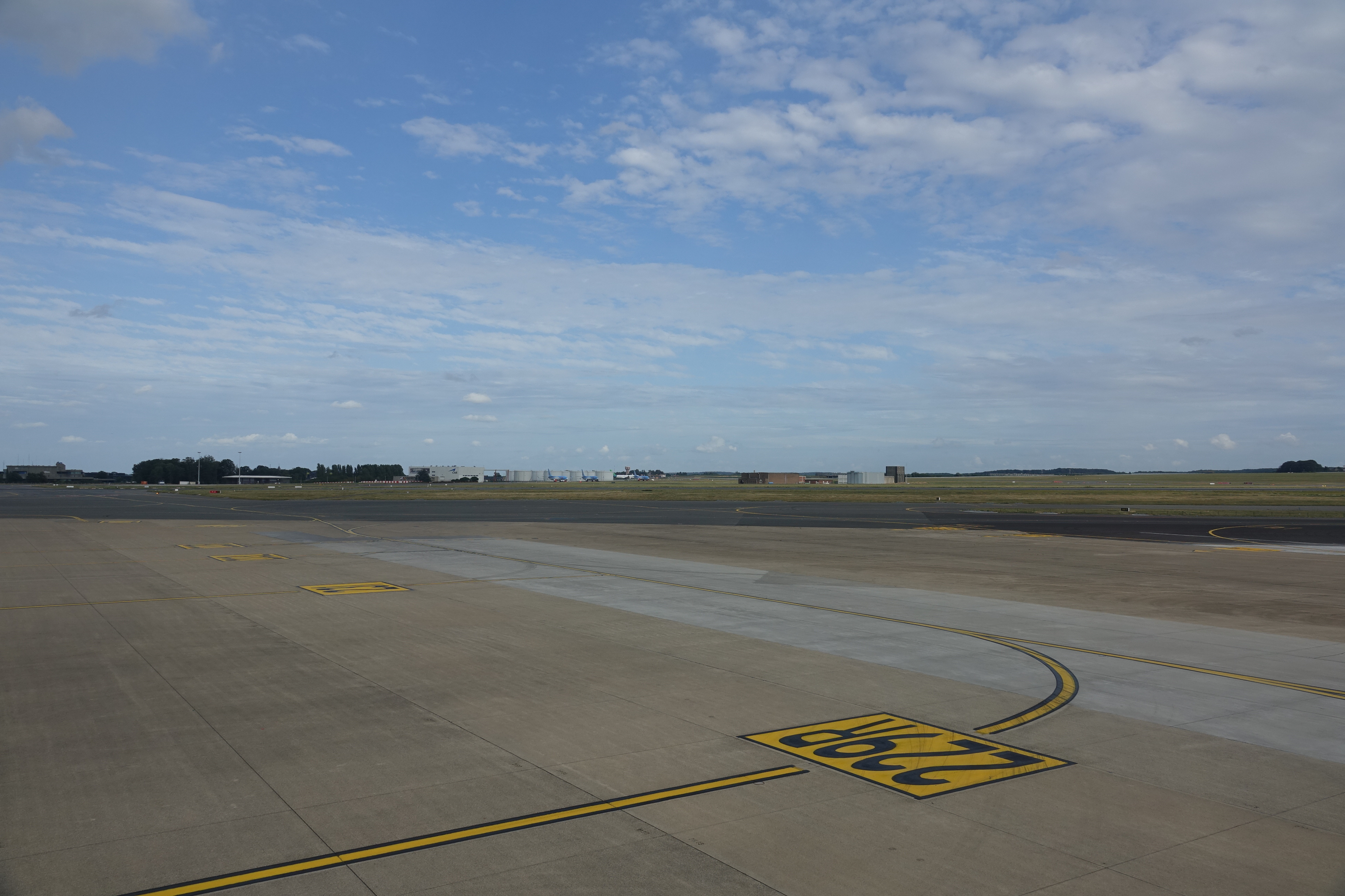 a runway with a yellow and black sign on it