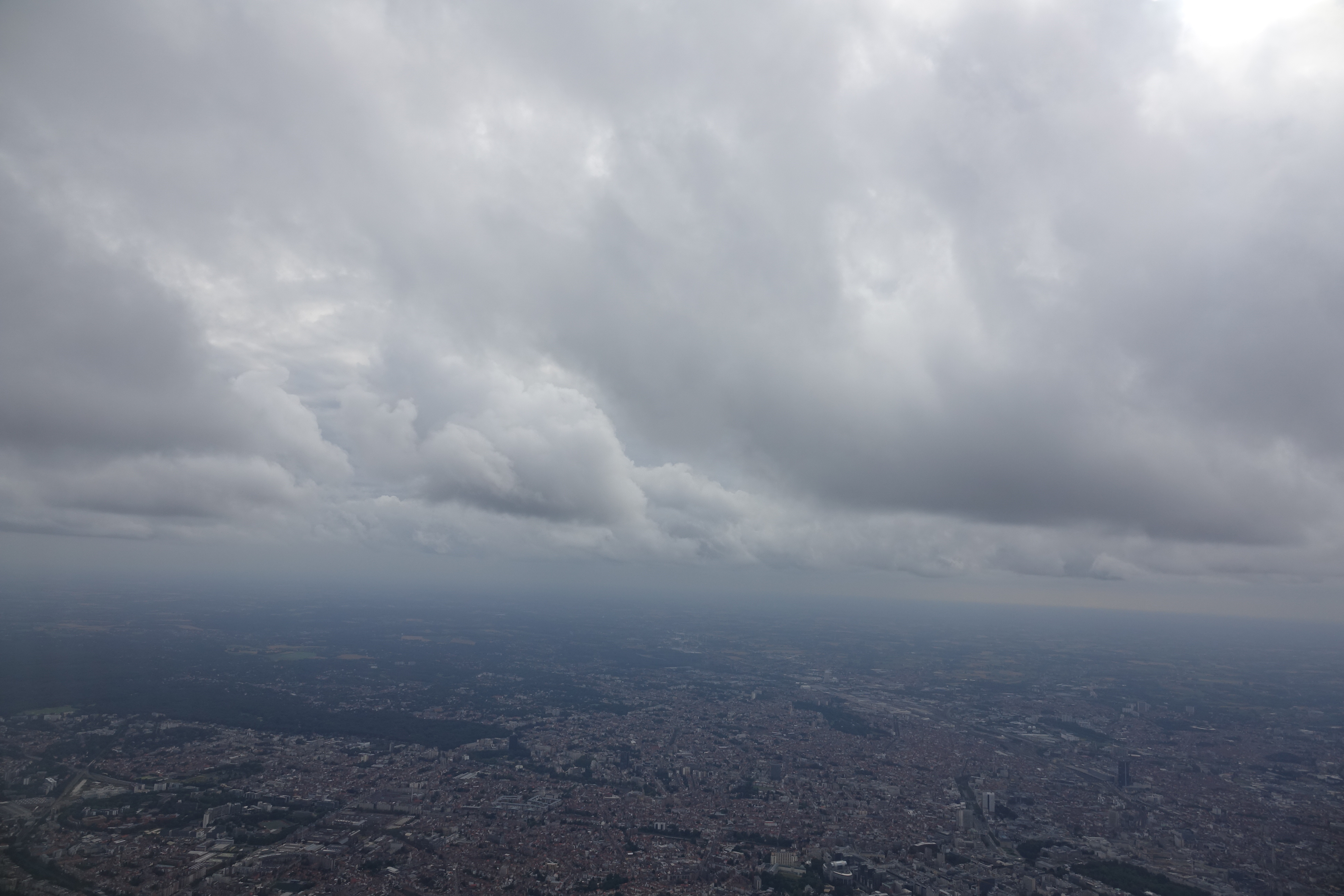 a city with many buildings and clouds