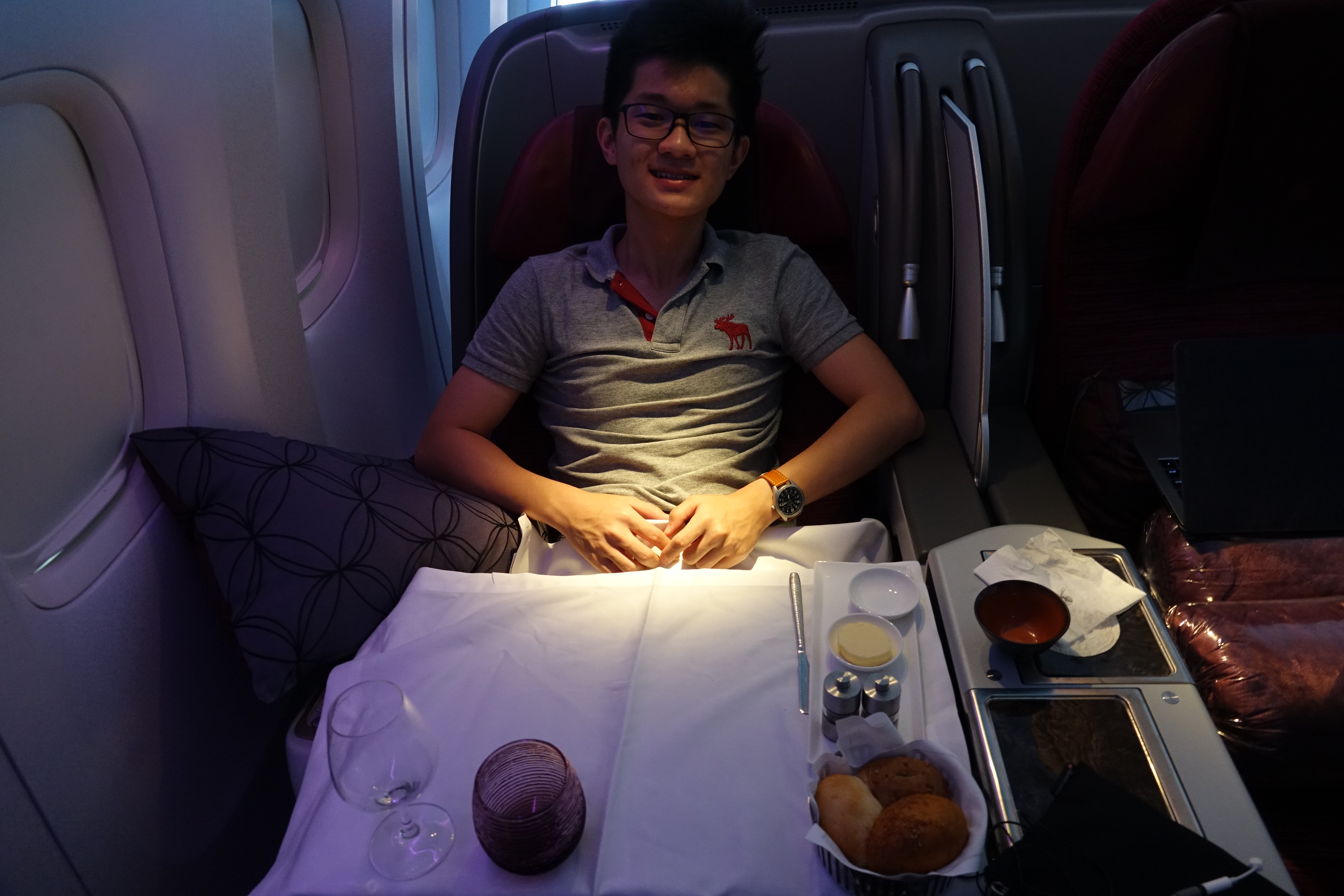 a man sitting in a chair with food on the table