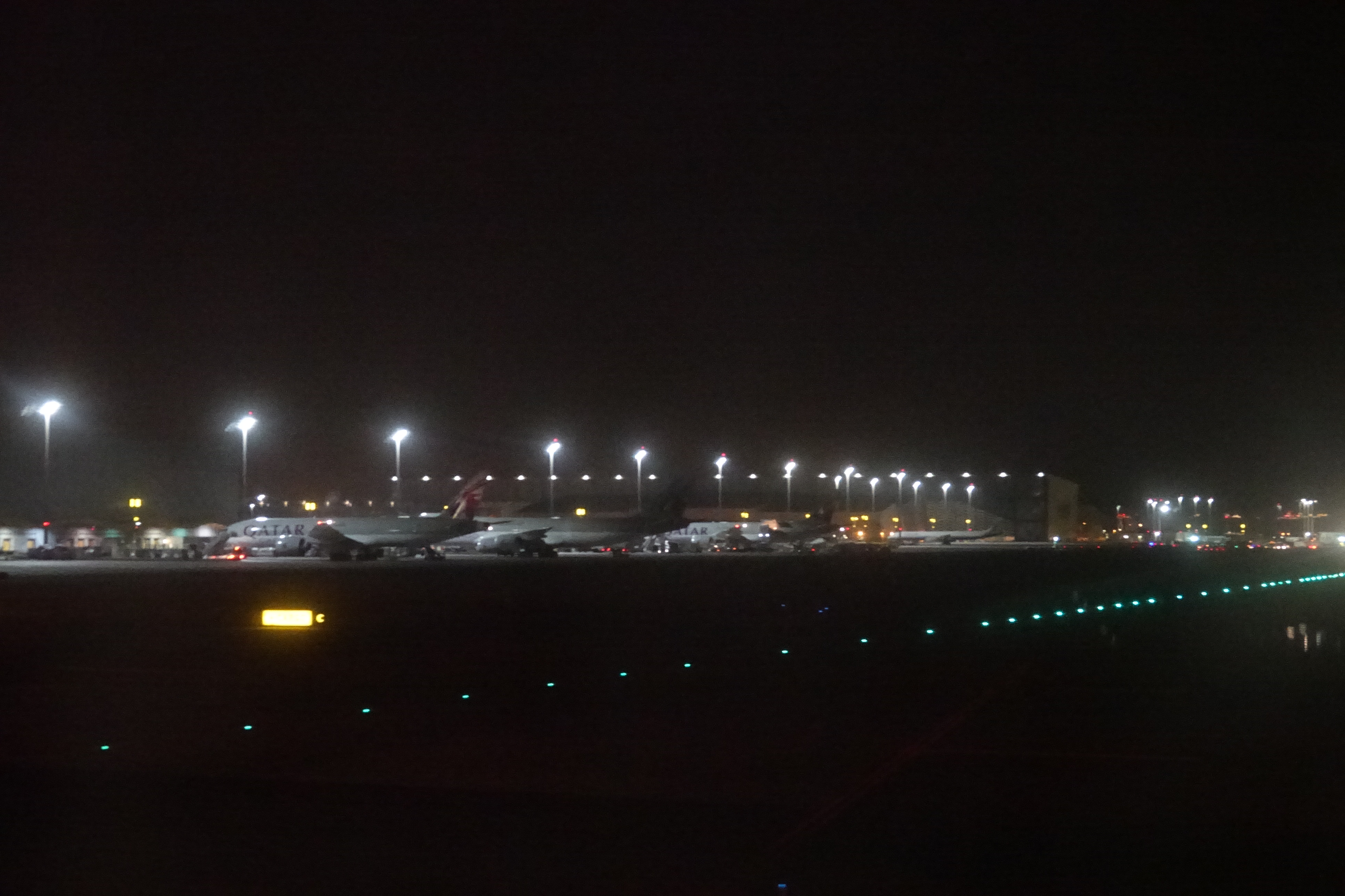 airplanes at night on a runway