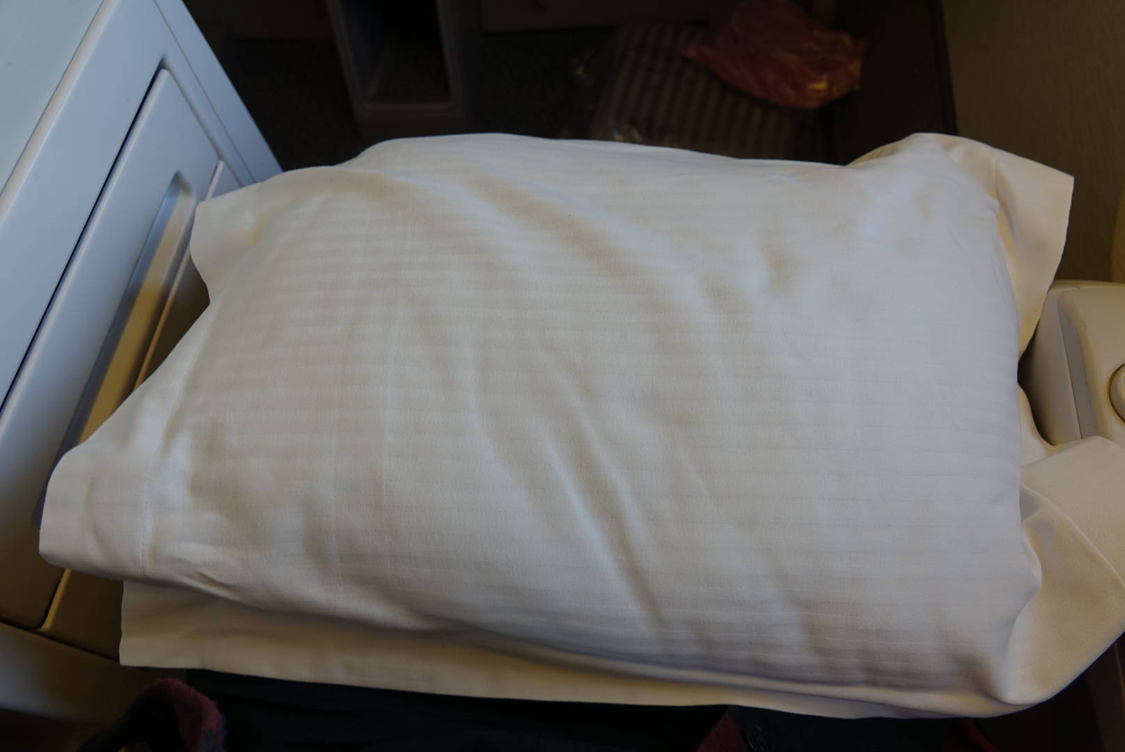 a white pillow on a bed