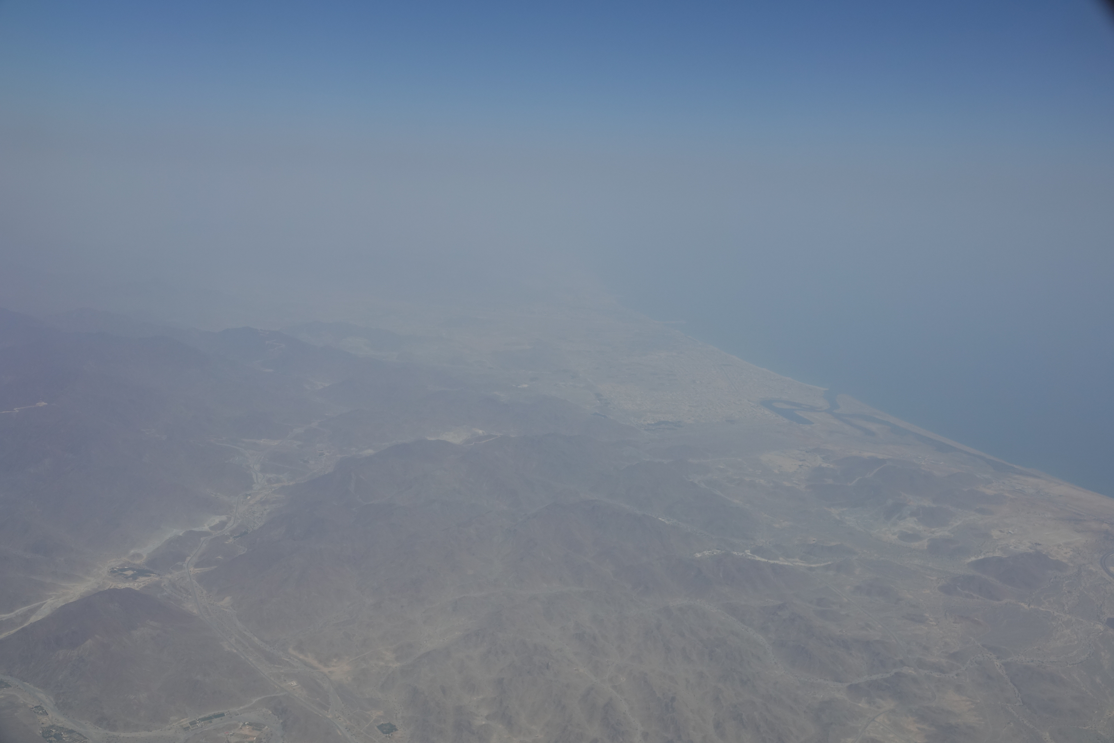 an aerial view of a large area with land and water