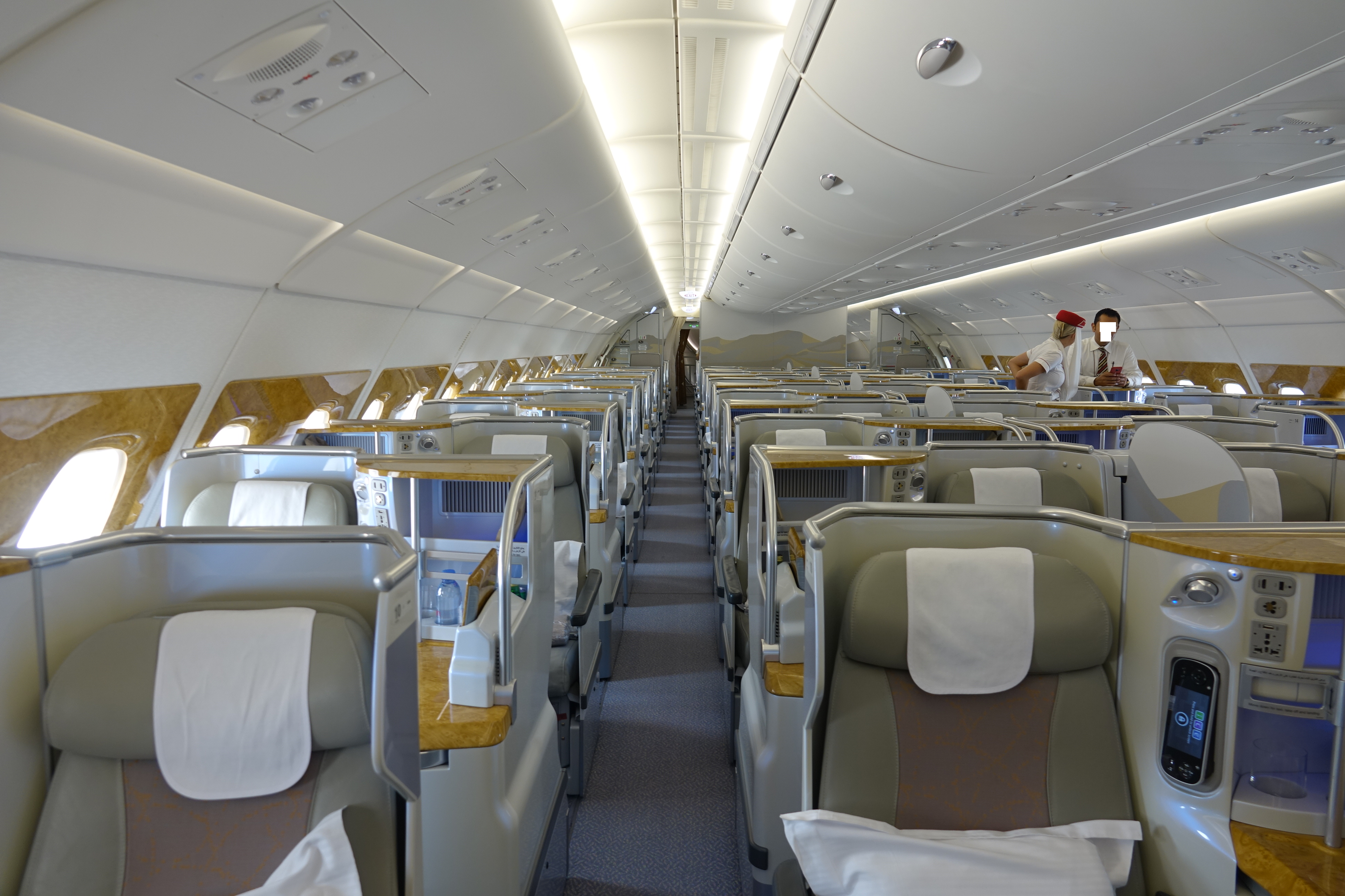 inside an airplane with seats and people in the background