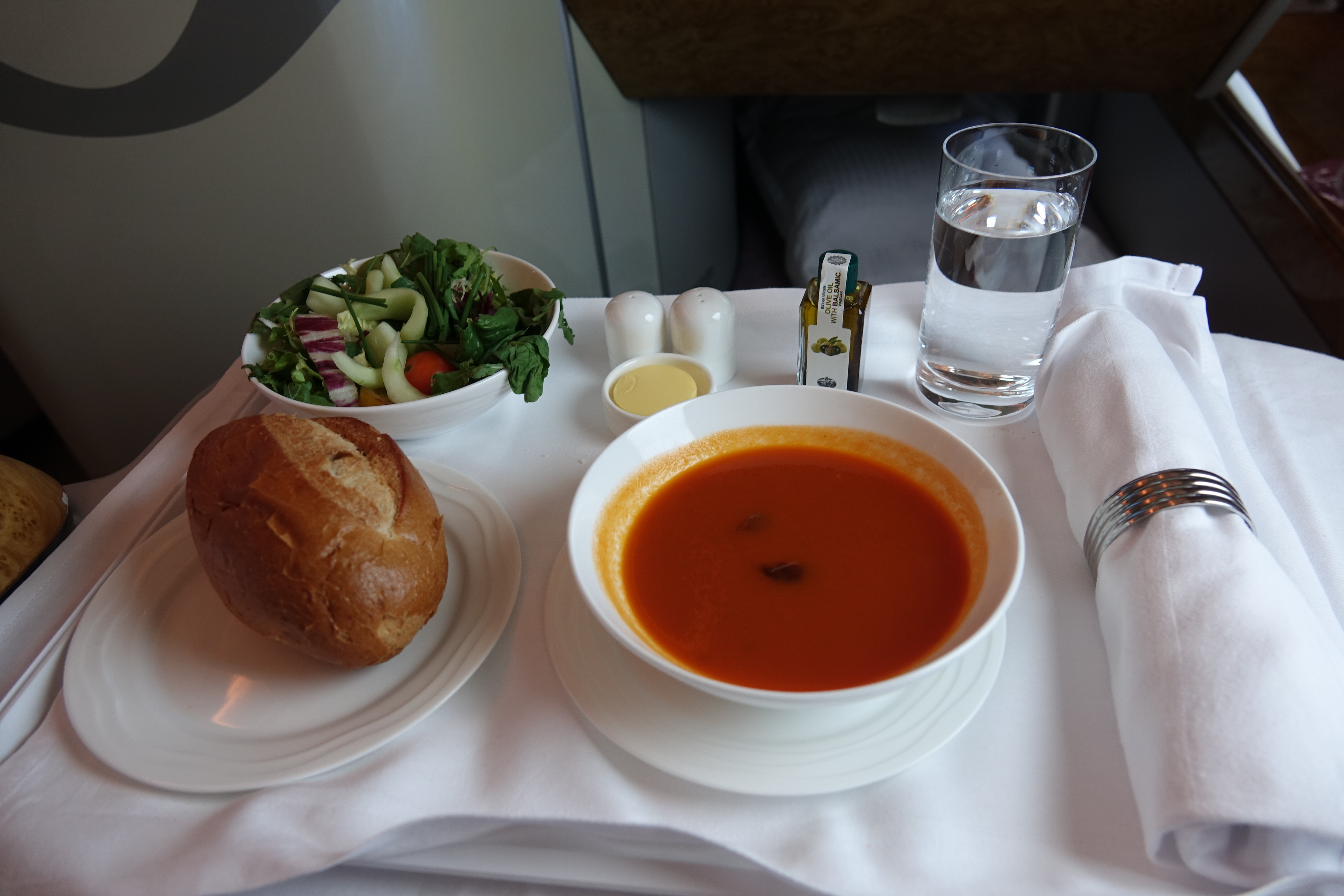 a bowl of soup and a bread on a table