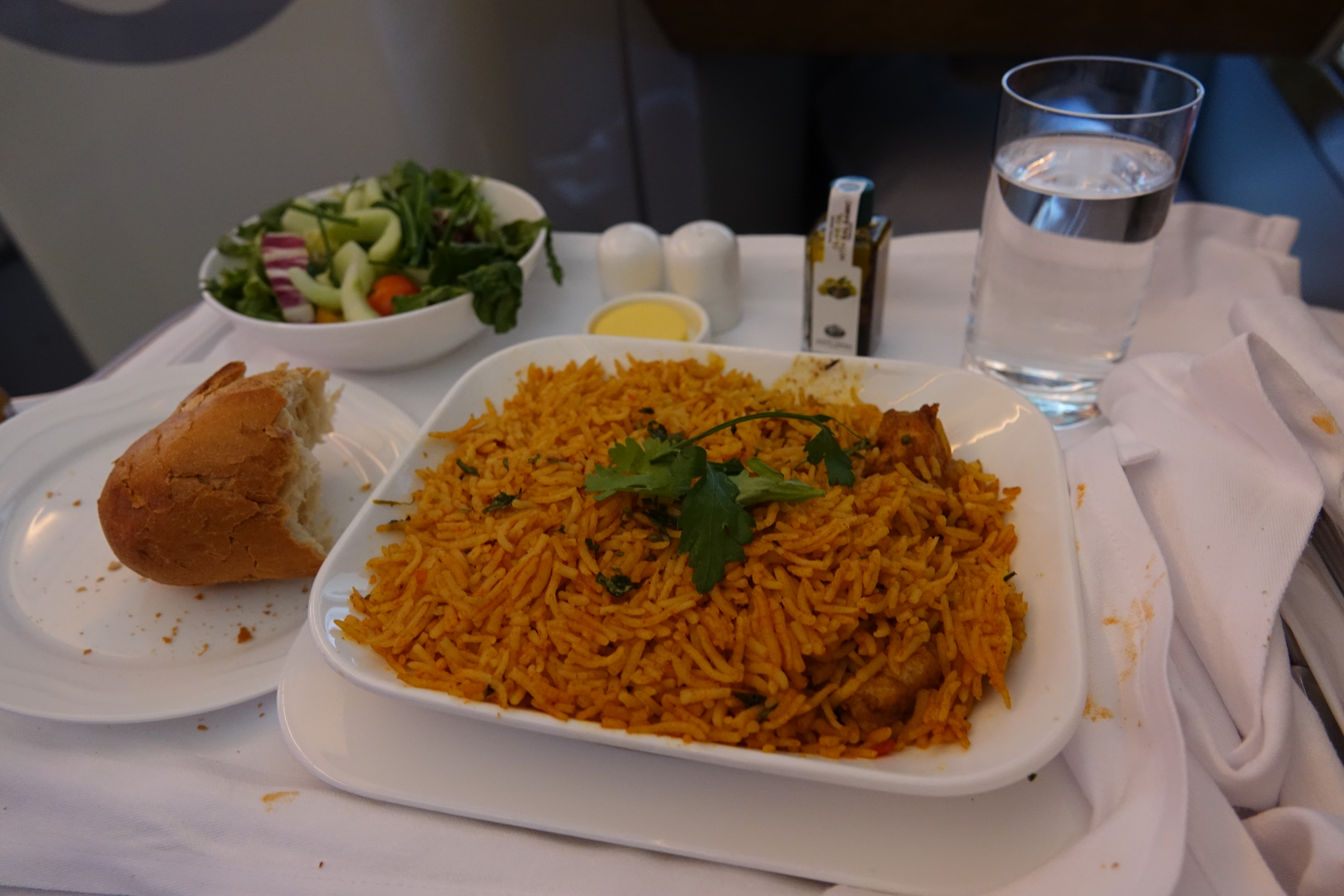 a plate of rice and salad on a table