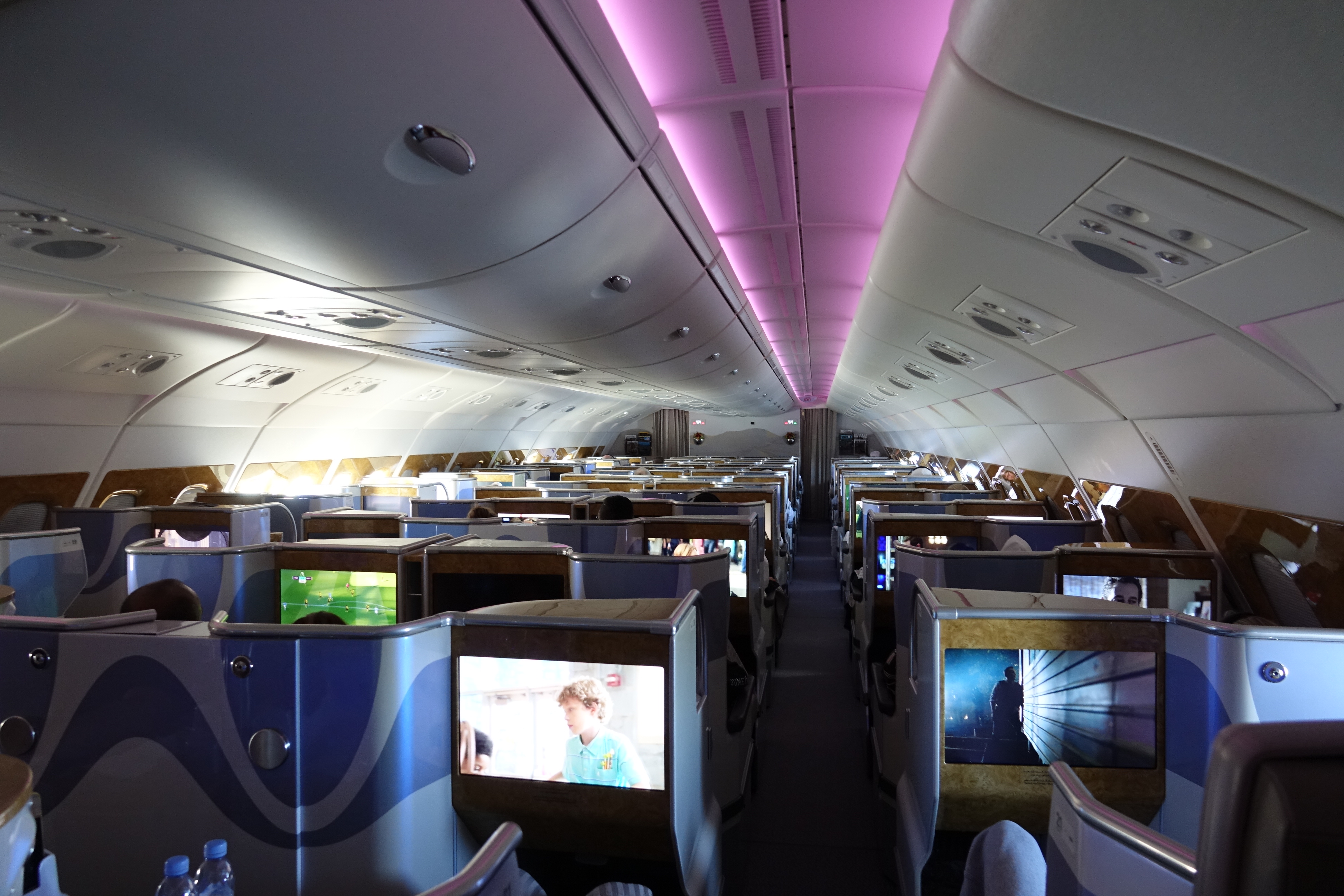 an airplane with rows of seats and monitors