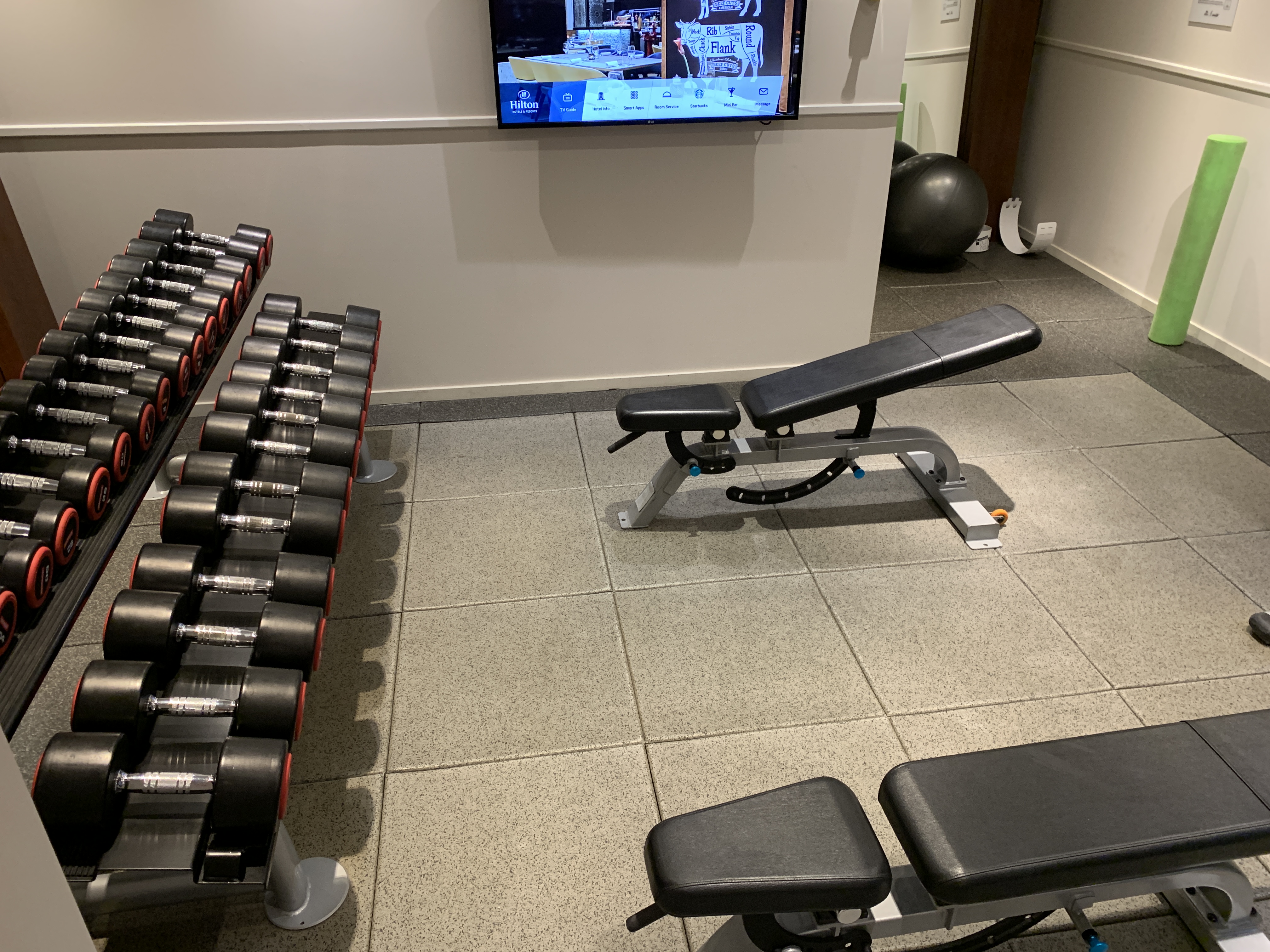 a gym with weights and a television