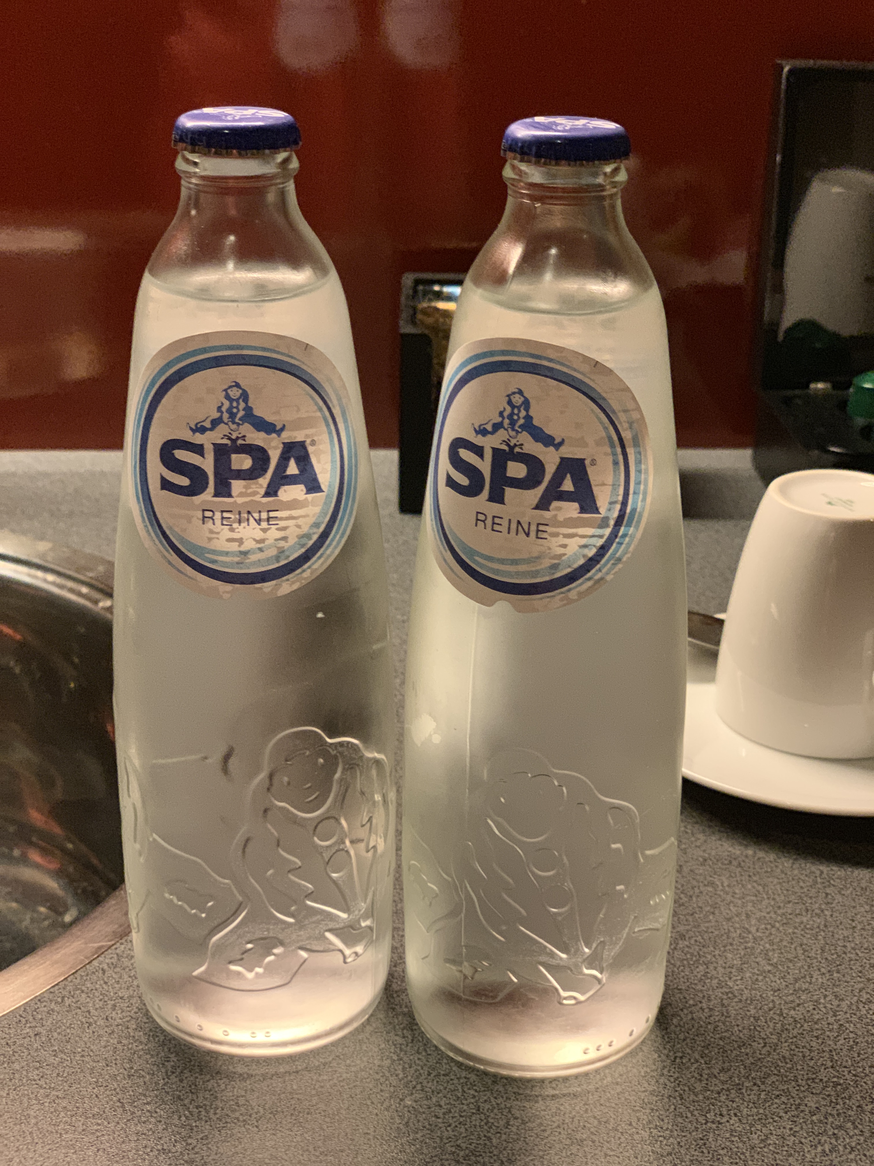 two bottles of water on a counter