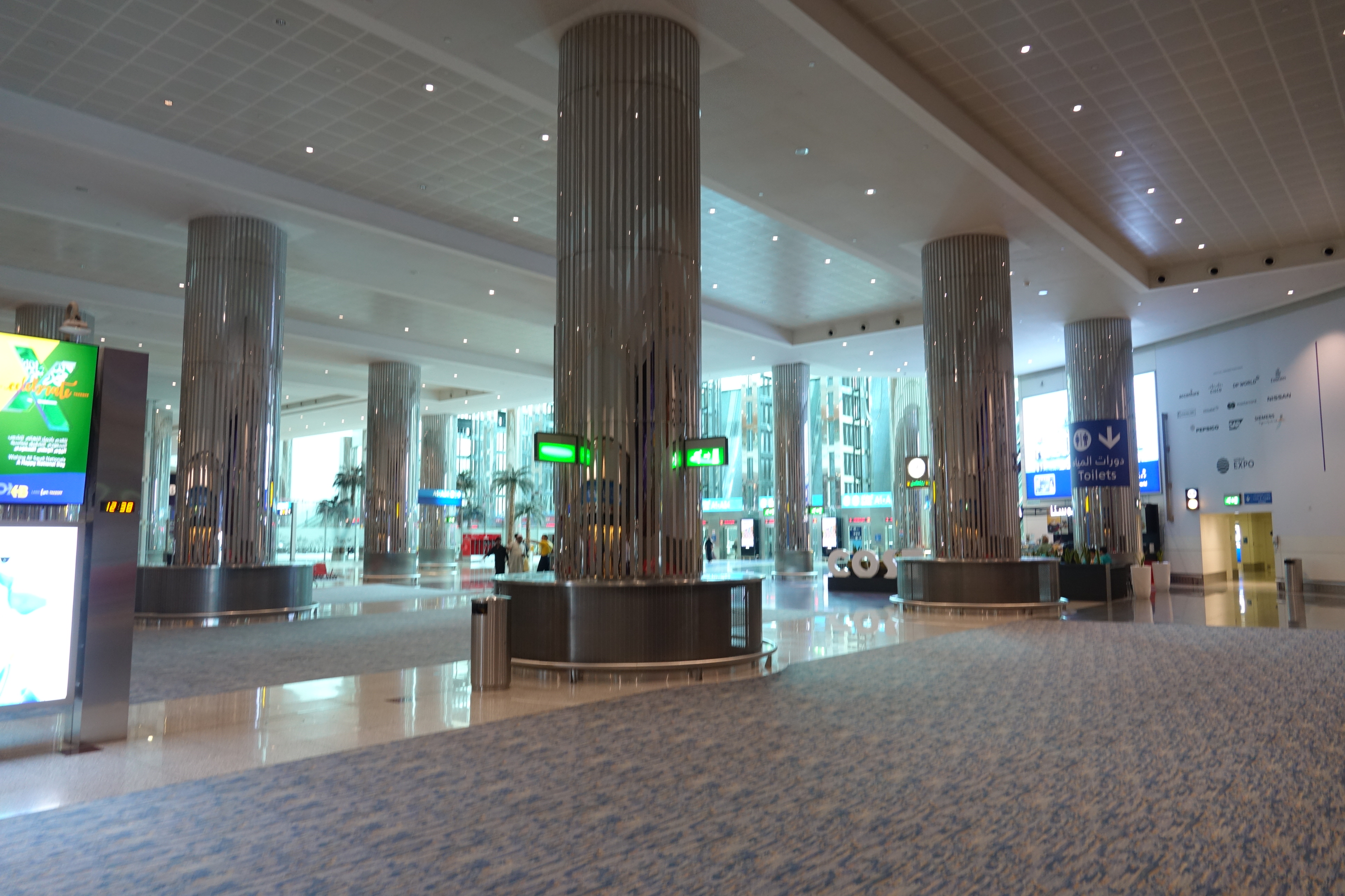 a large hall with columns and signs