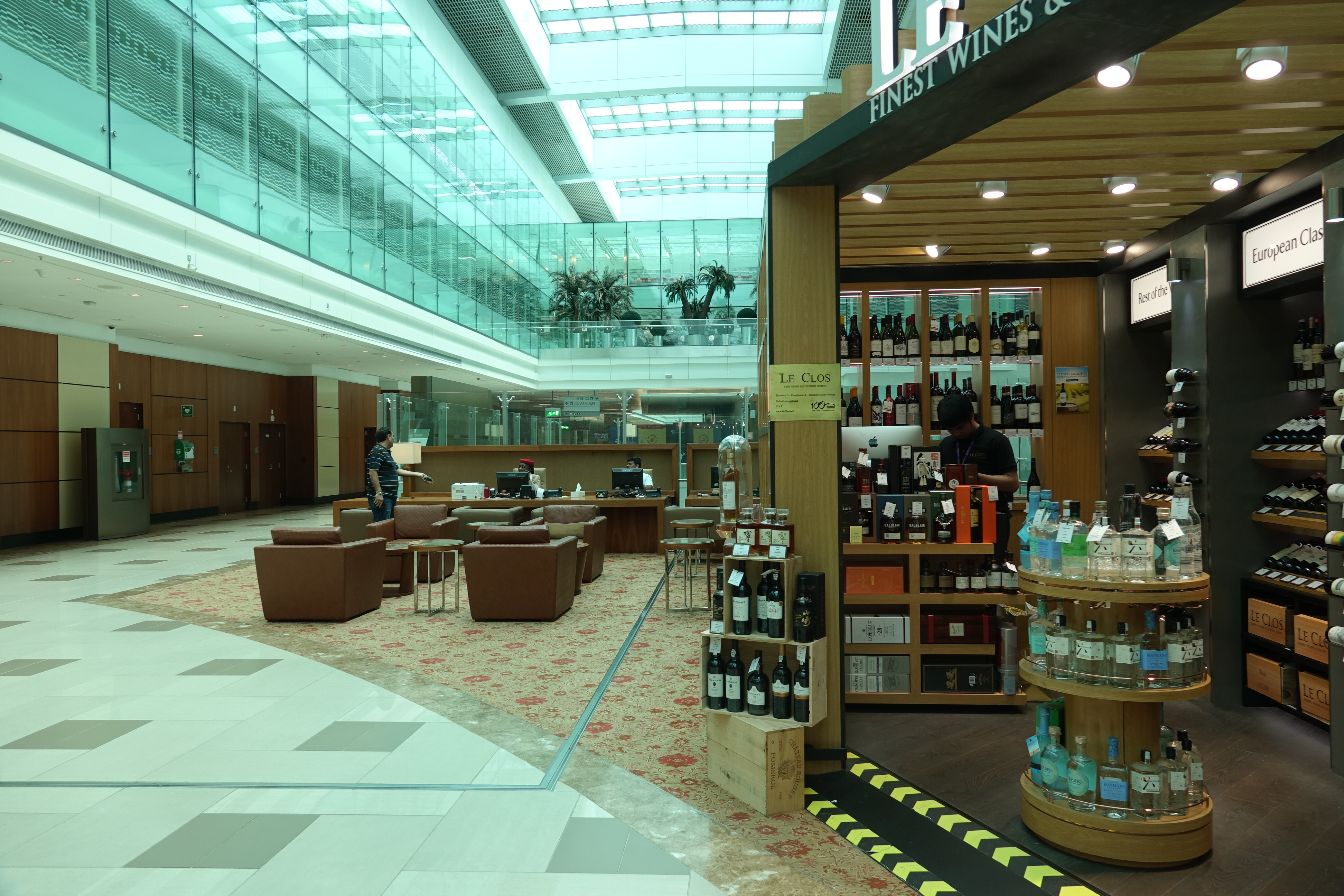 a store with shelves of wine and chairs