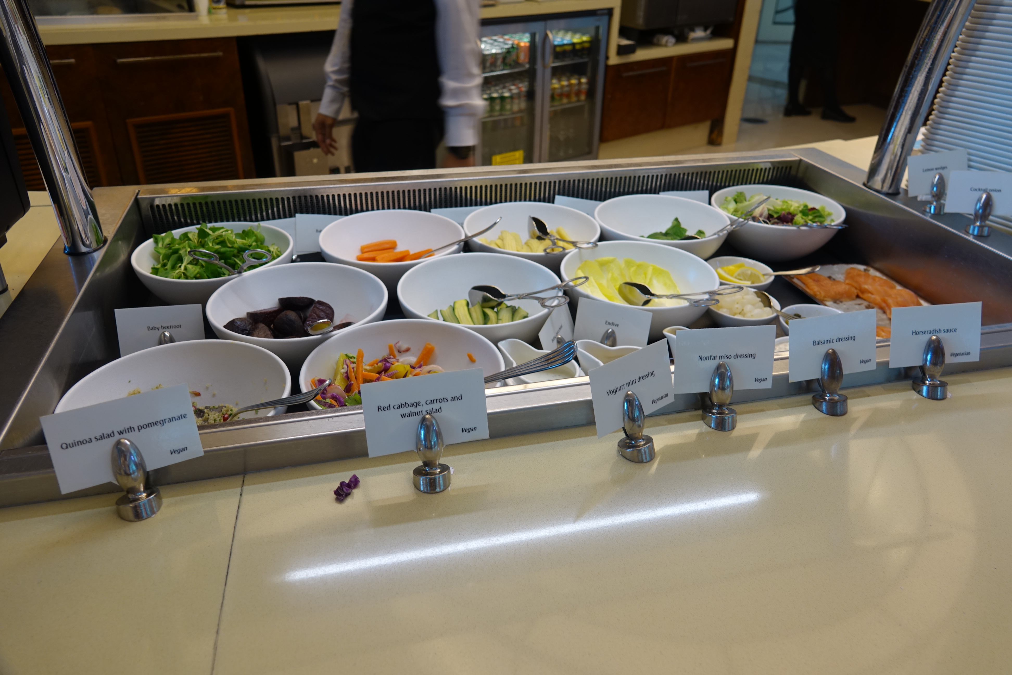 a salad bar with bowls of food