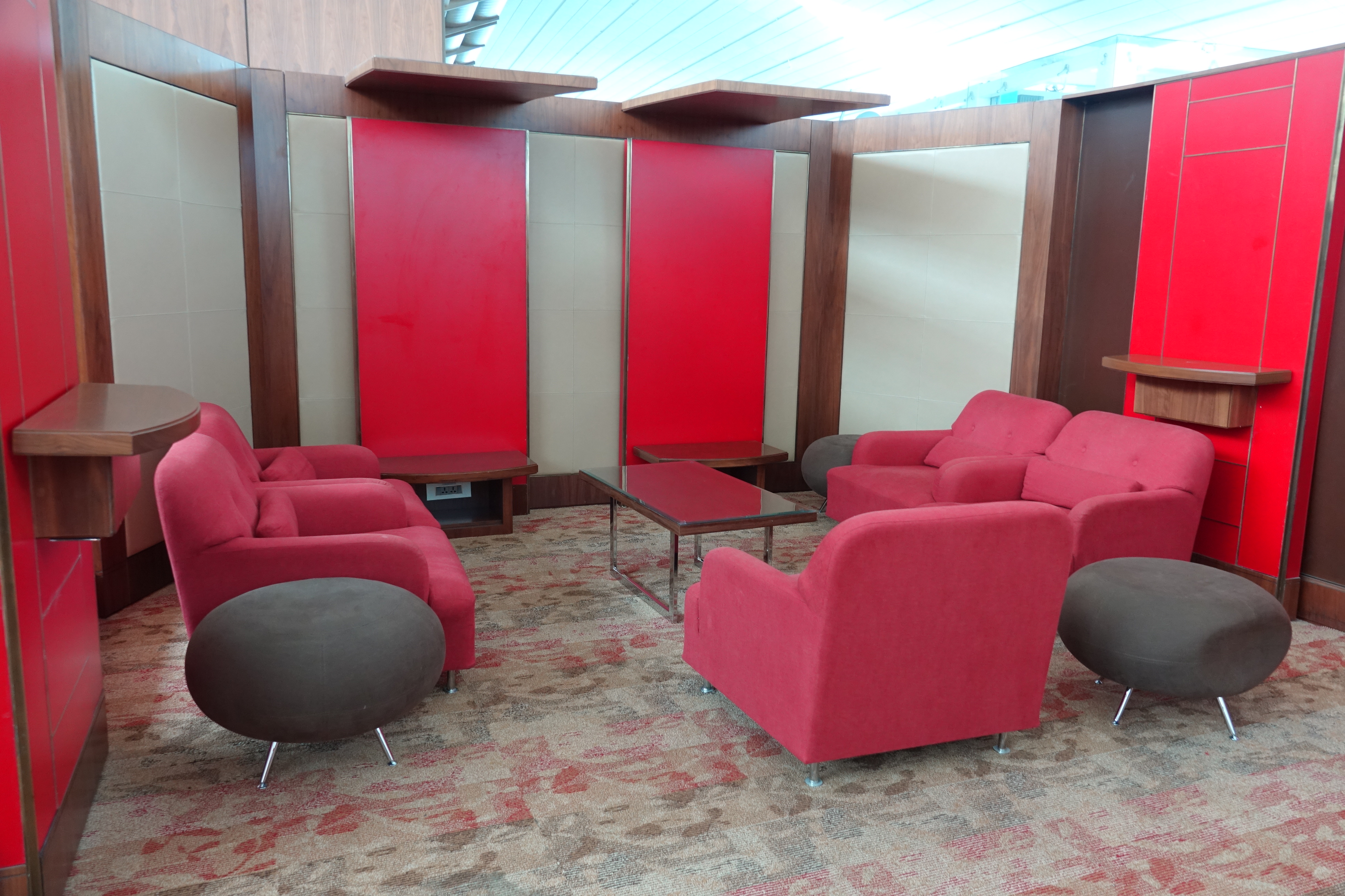 a room with red chairs and a table