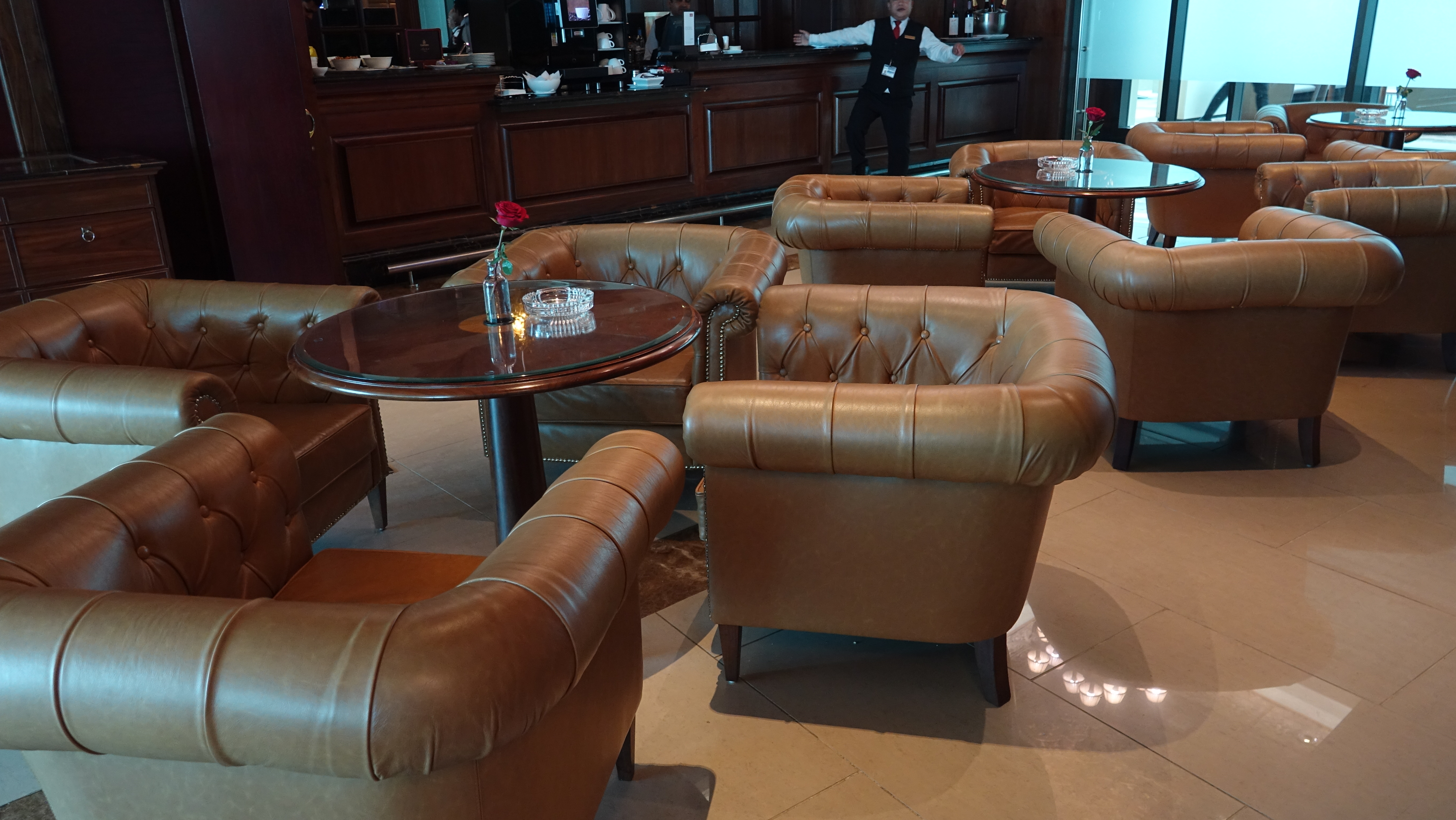 a group of leather chairs and tables in a room