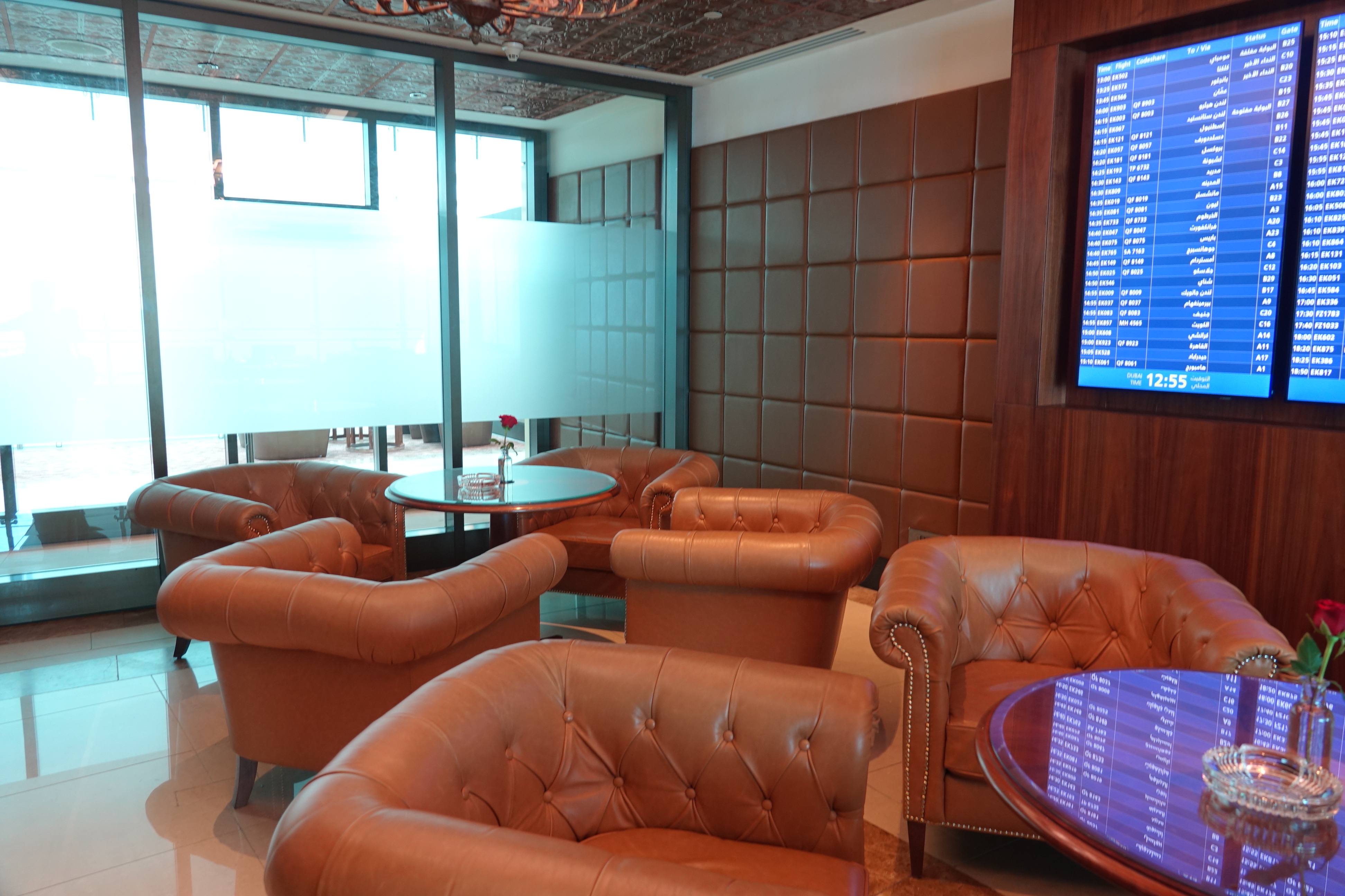 a room with brown leather chairs and a table