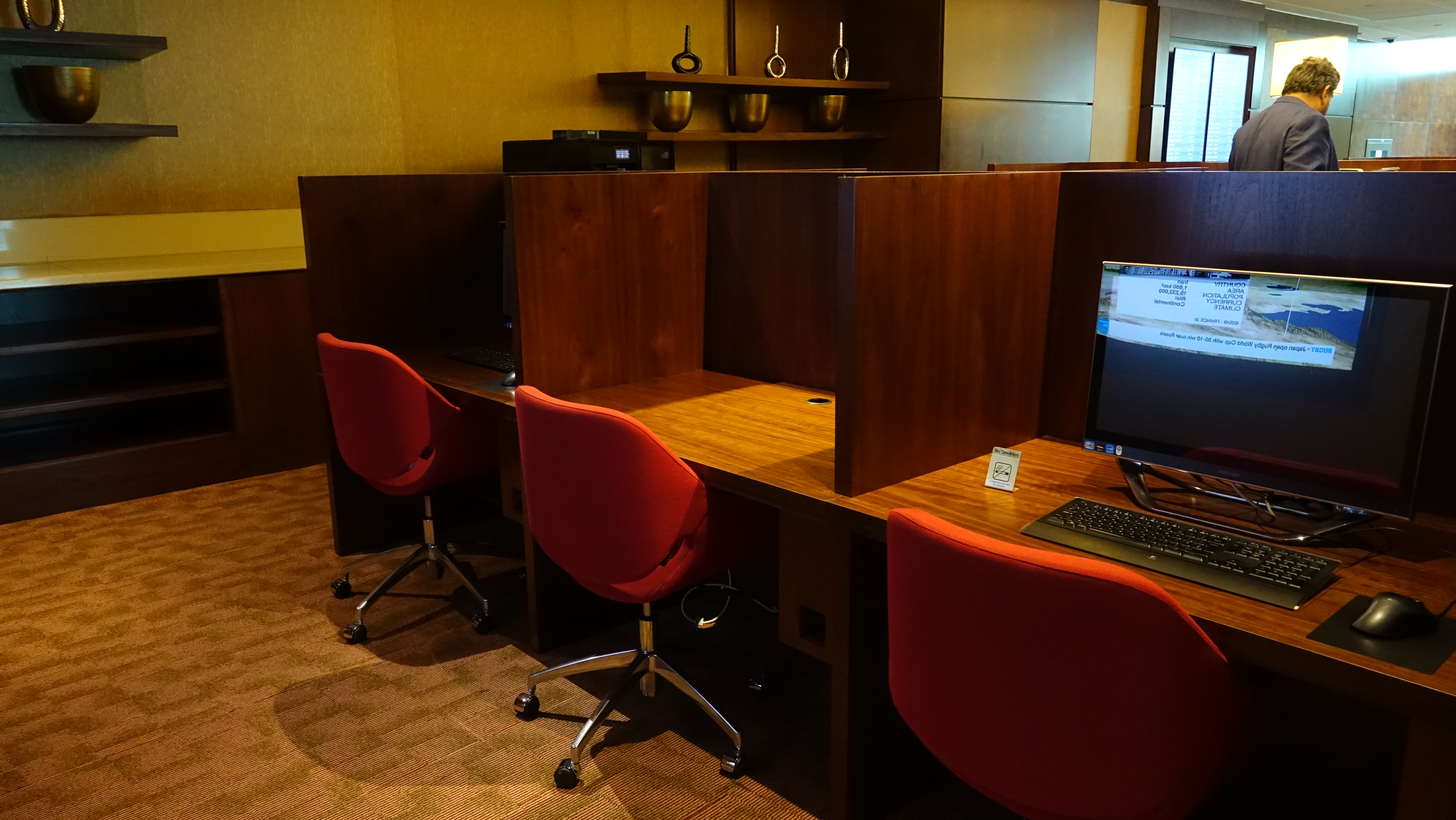 a desks with computers and chairs in a room