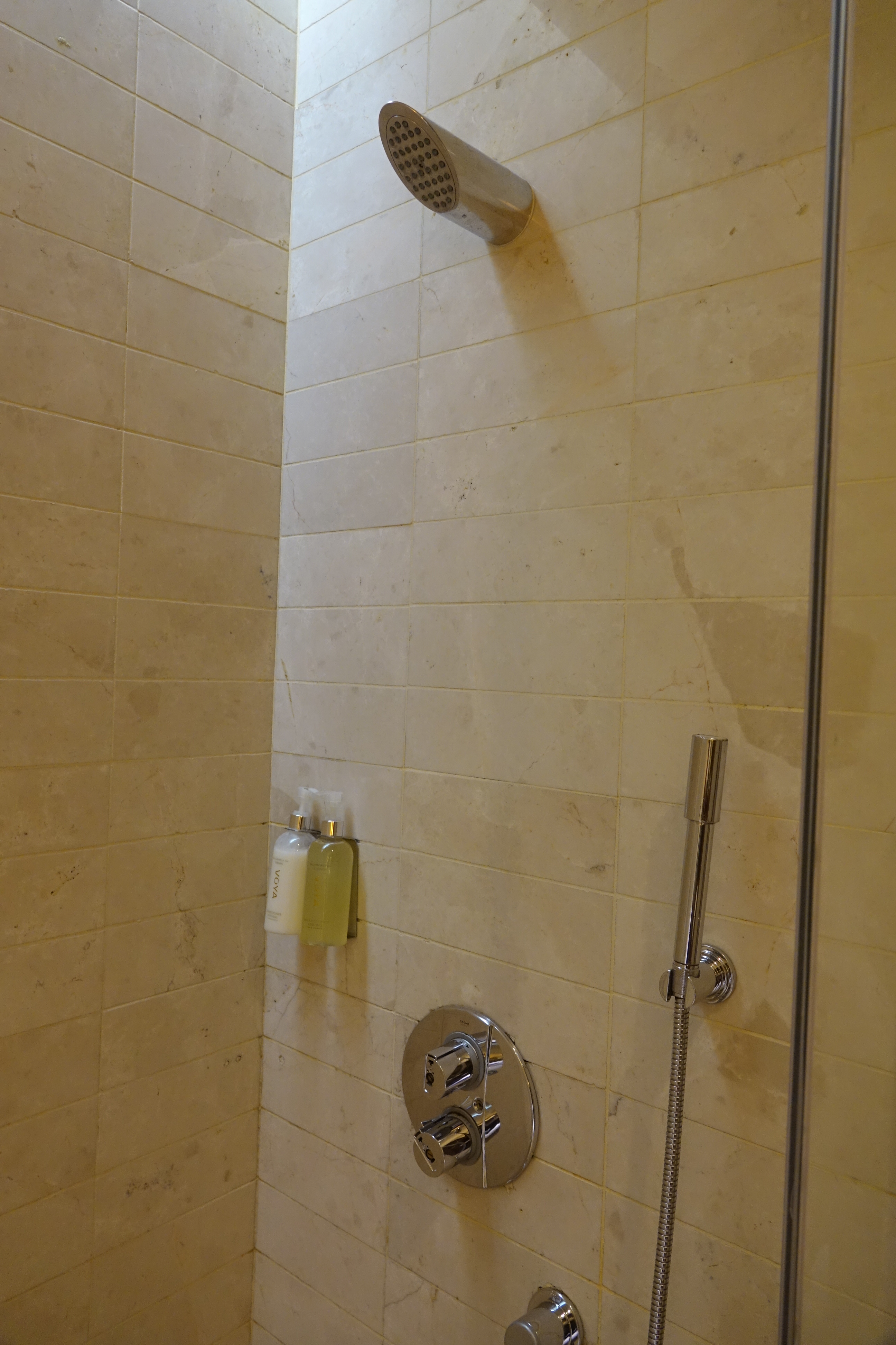 a shower with a shower head and shower head