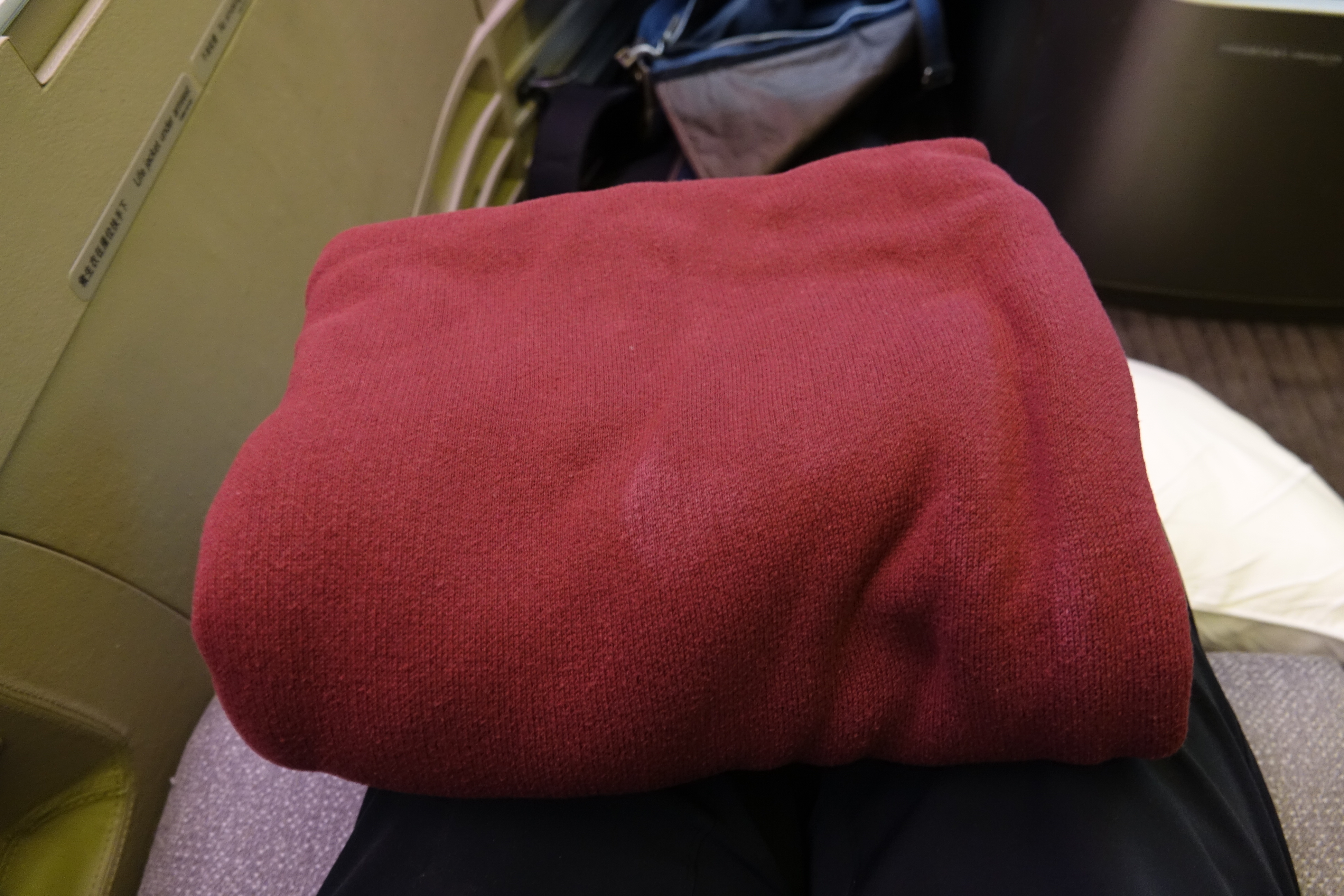 a red blanket on a person's lap