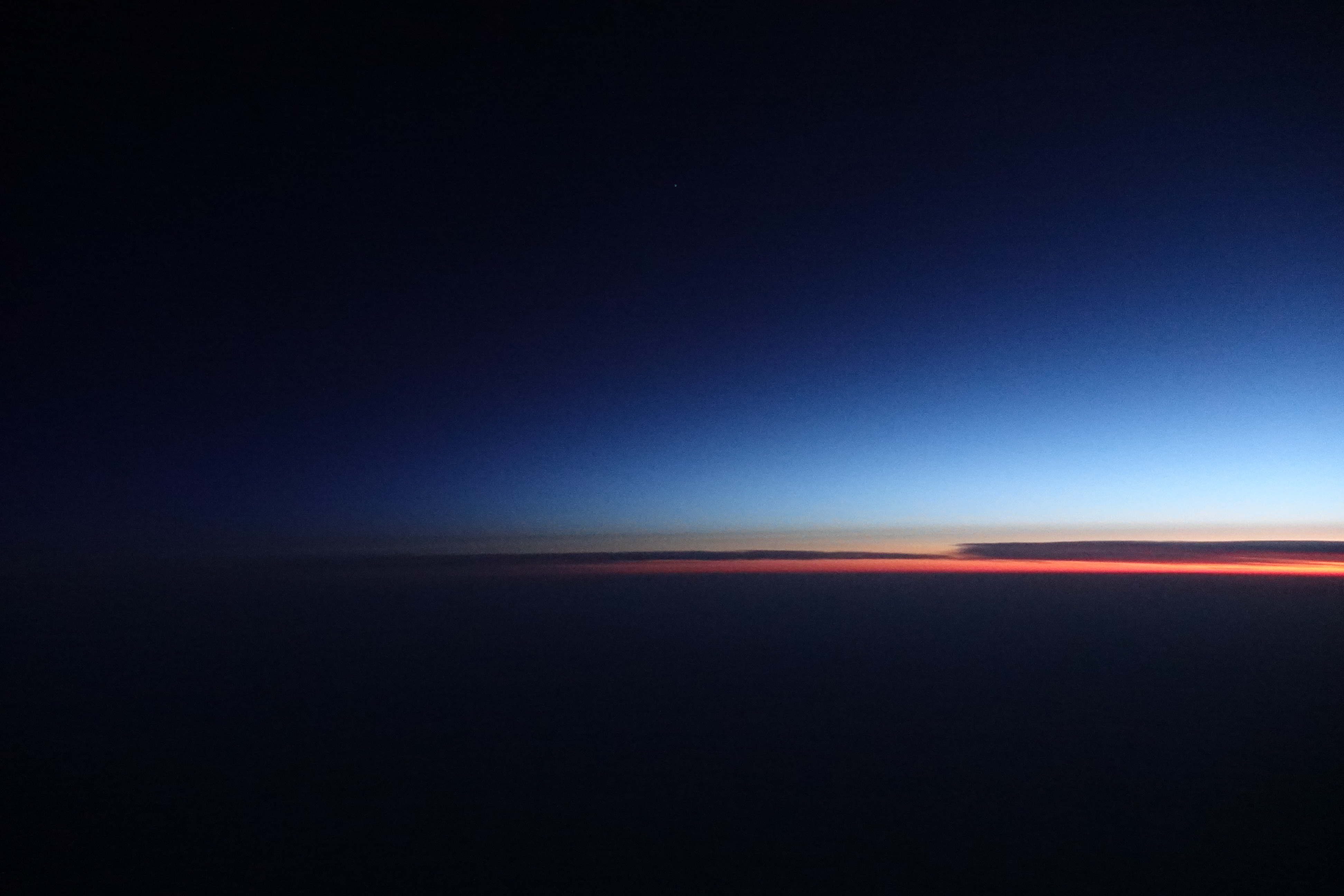 a blue and orange sky with Marfa lights in the background