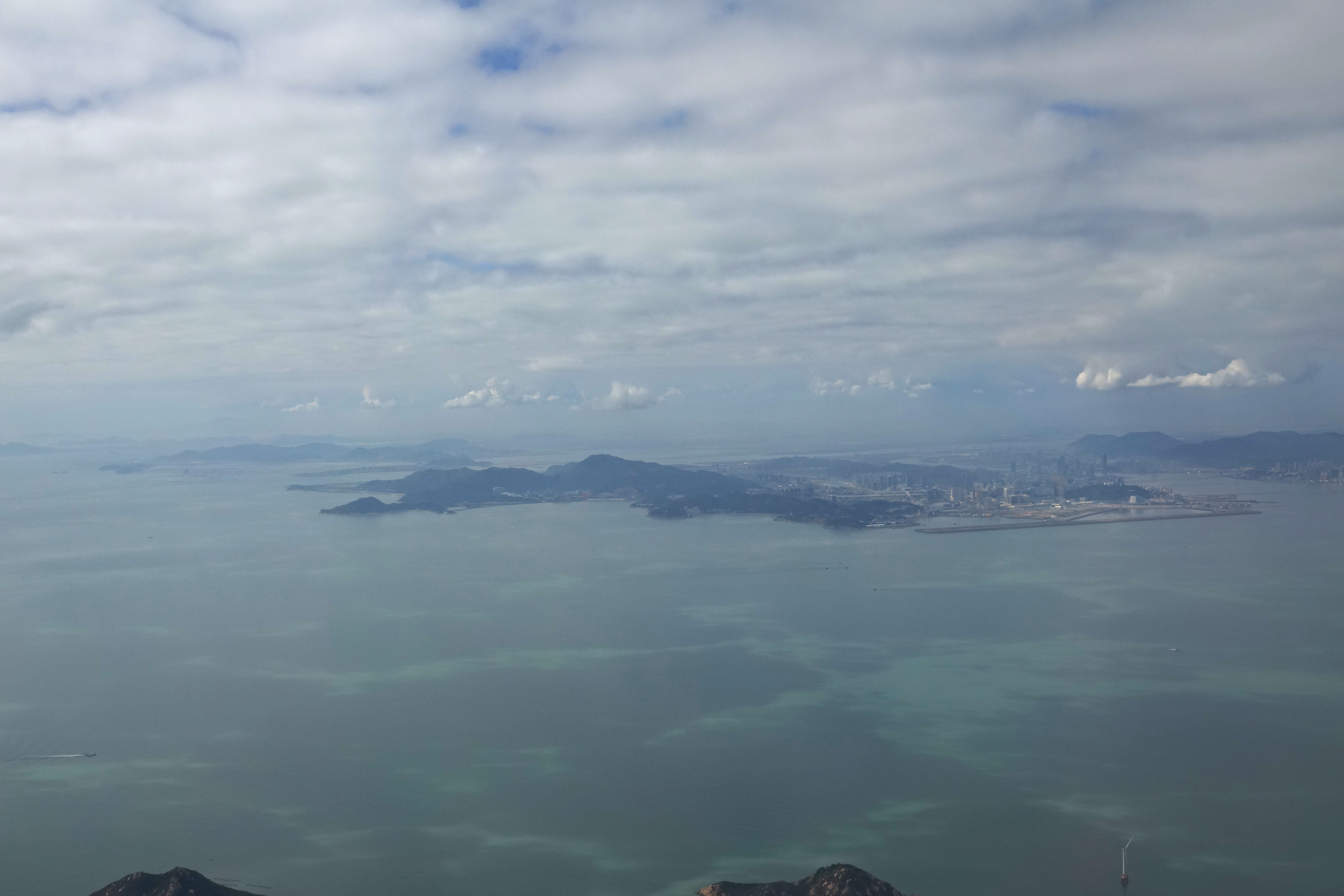 a large body of water with a city in the distance