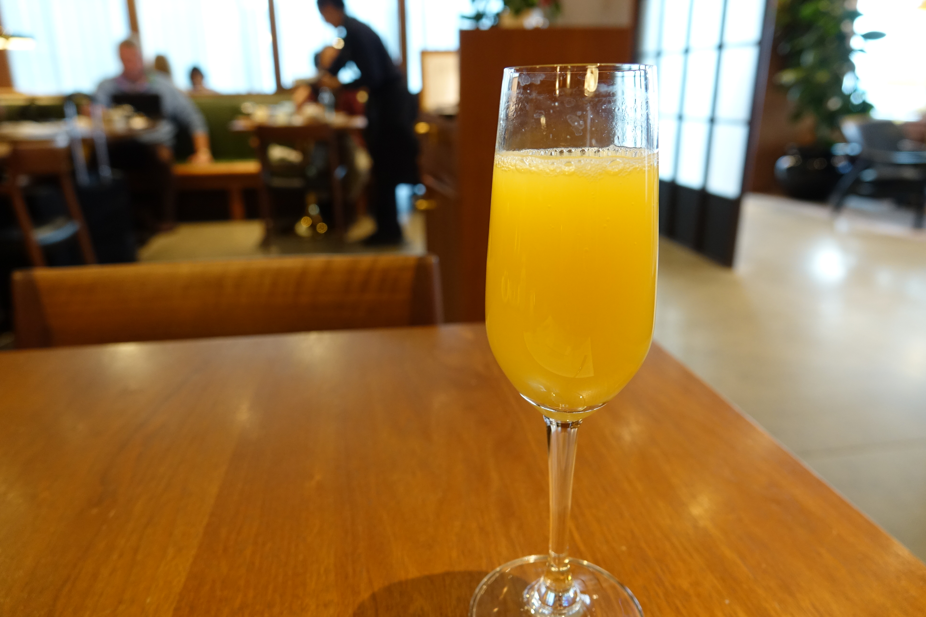 a glass of orange juice on a table