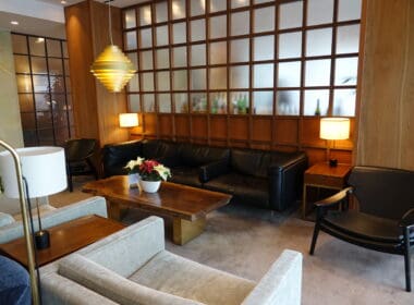 a room with a couch and chairs