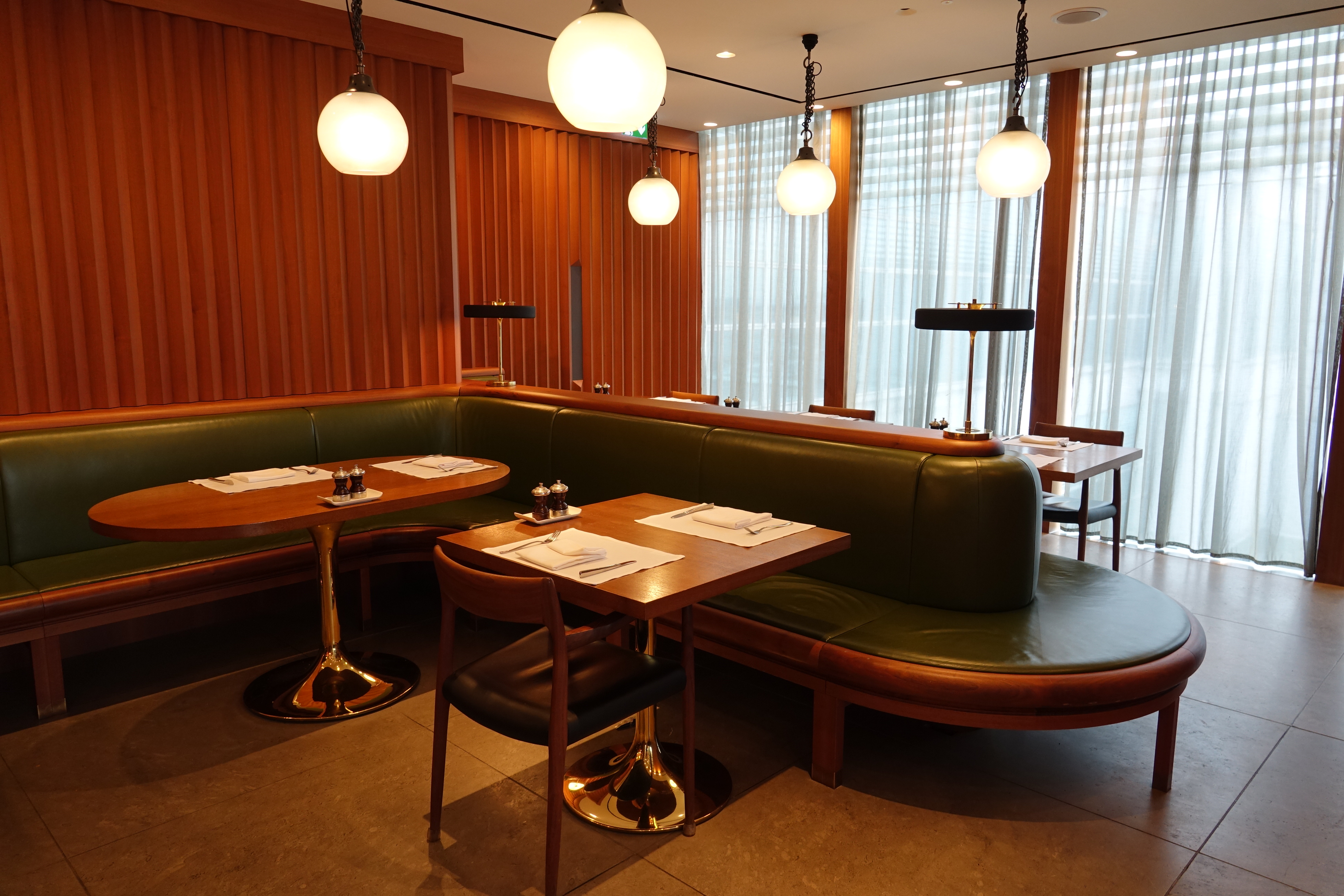 a booth seating with lights from the ceiling