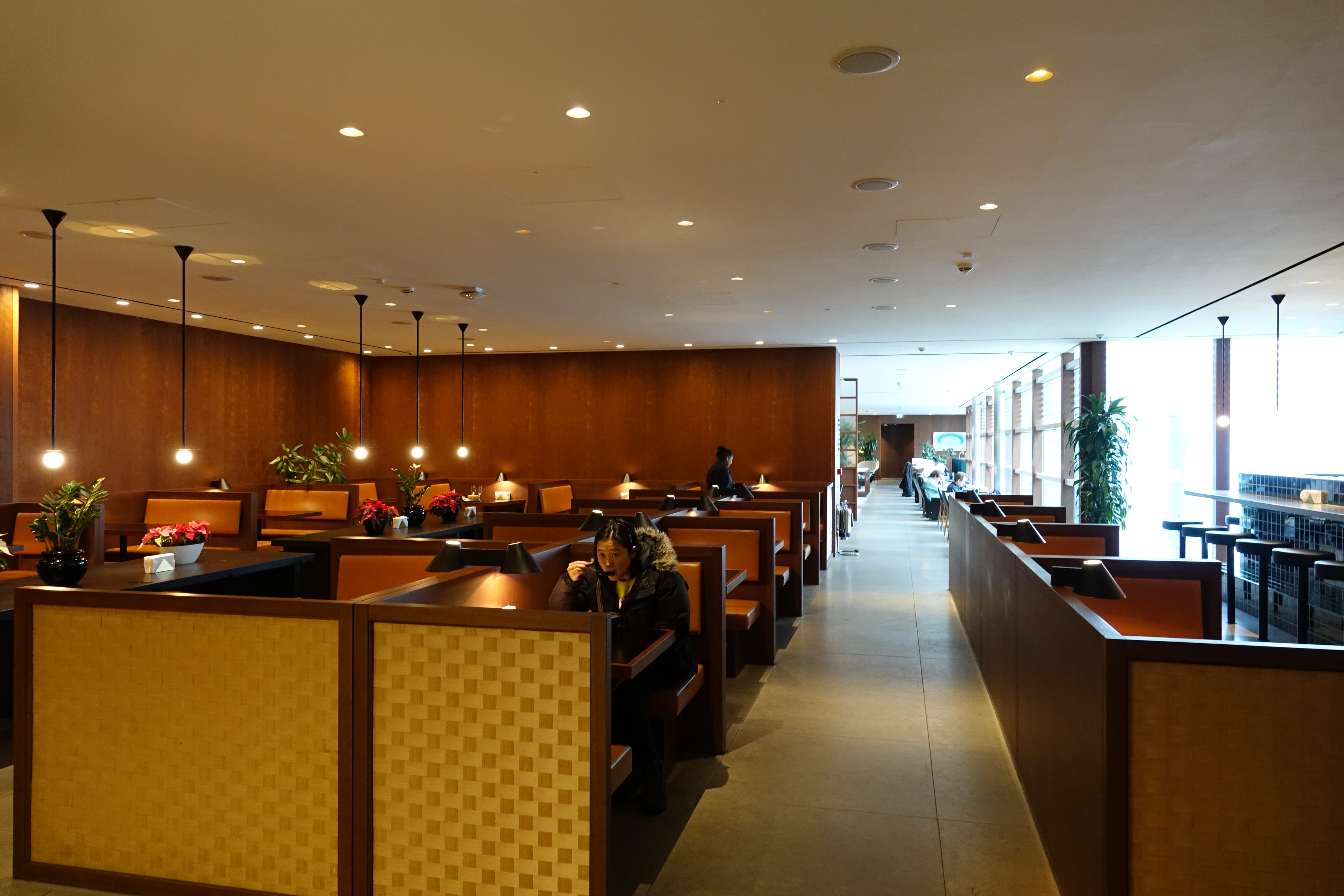 a room with tables and chairs with people sitting in it