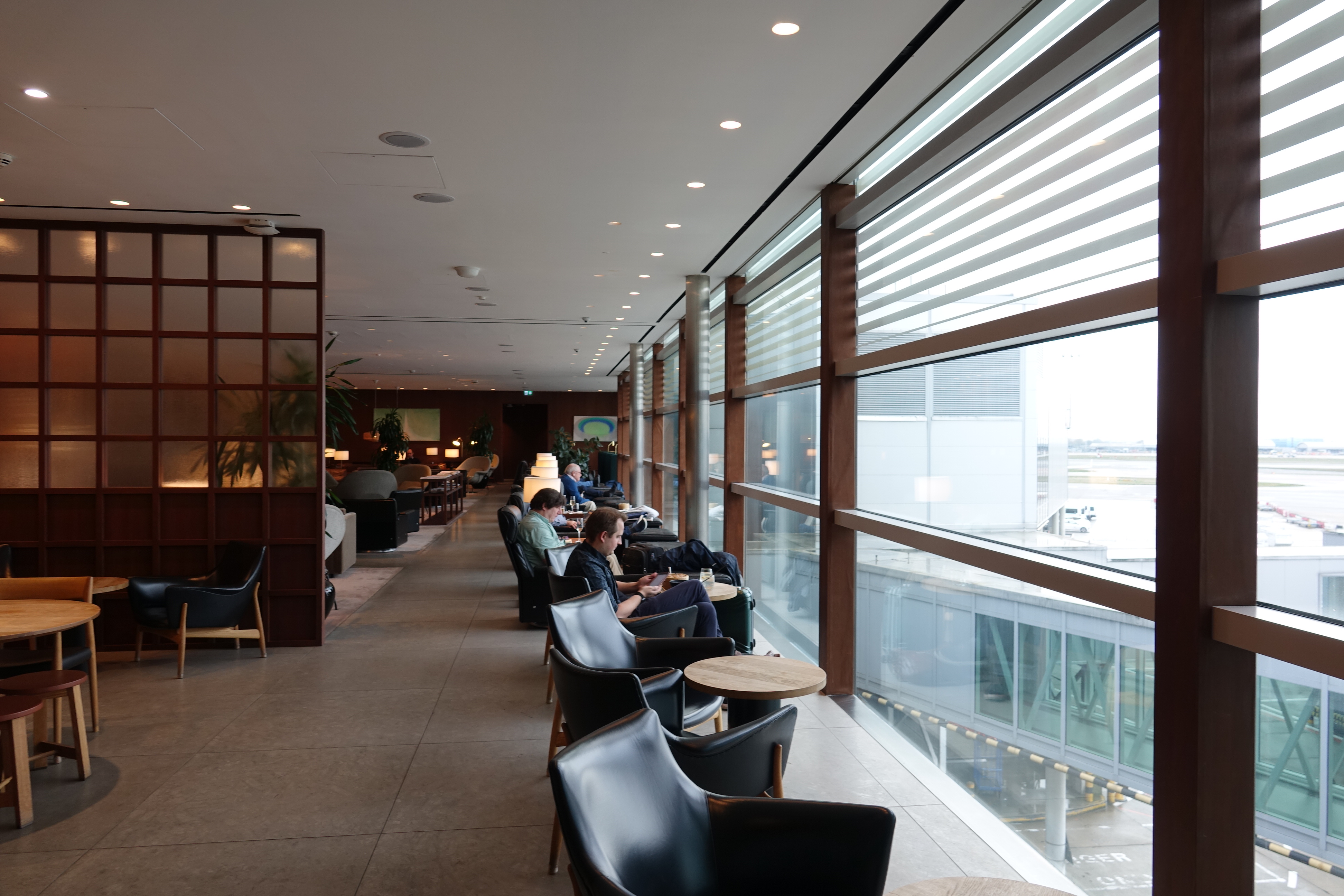 people sitting in a room with chairs and tables