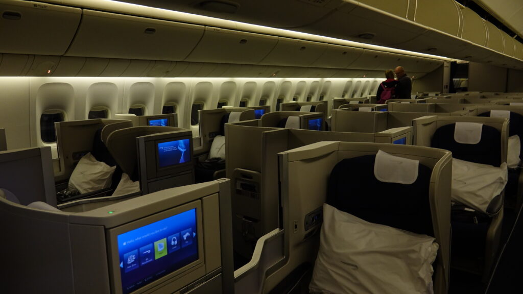 a row of seats with a television on the side