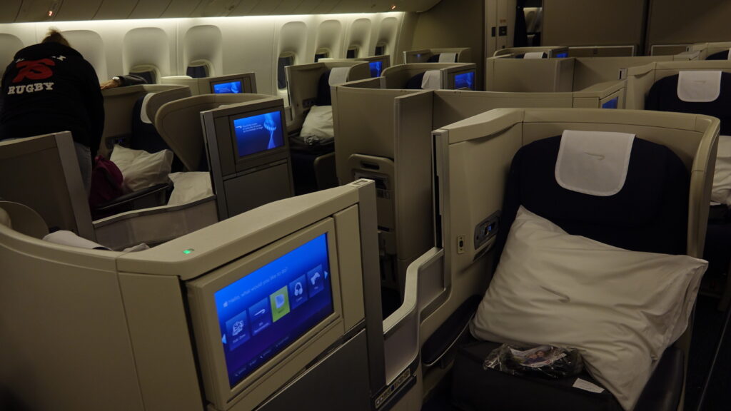 a seat in an airplane with a tv and a screen