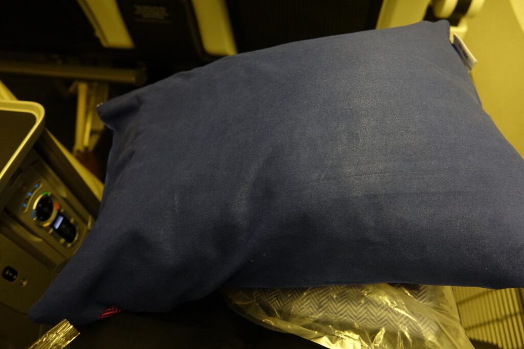 a blue pillow on a plastic bag