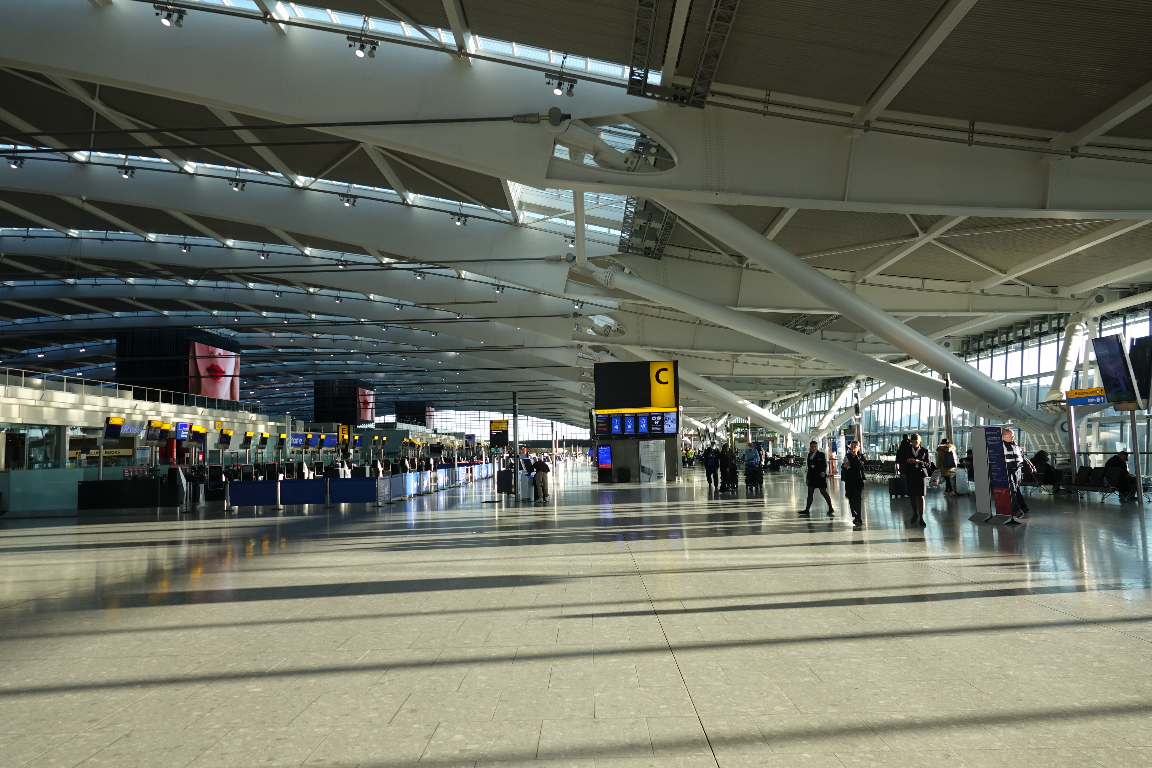 a large airport with people walking around