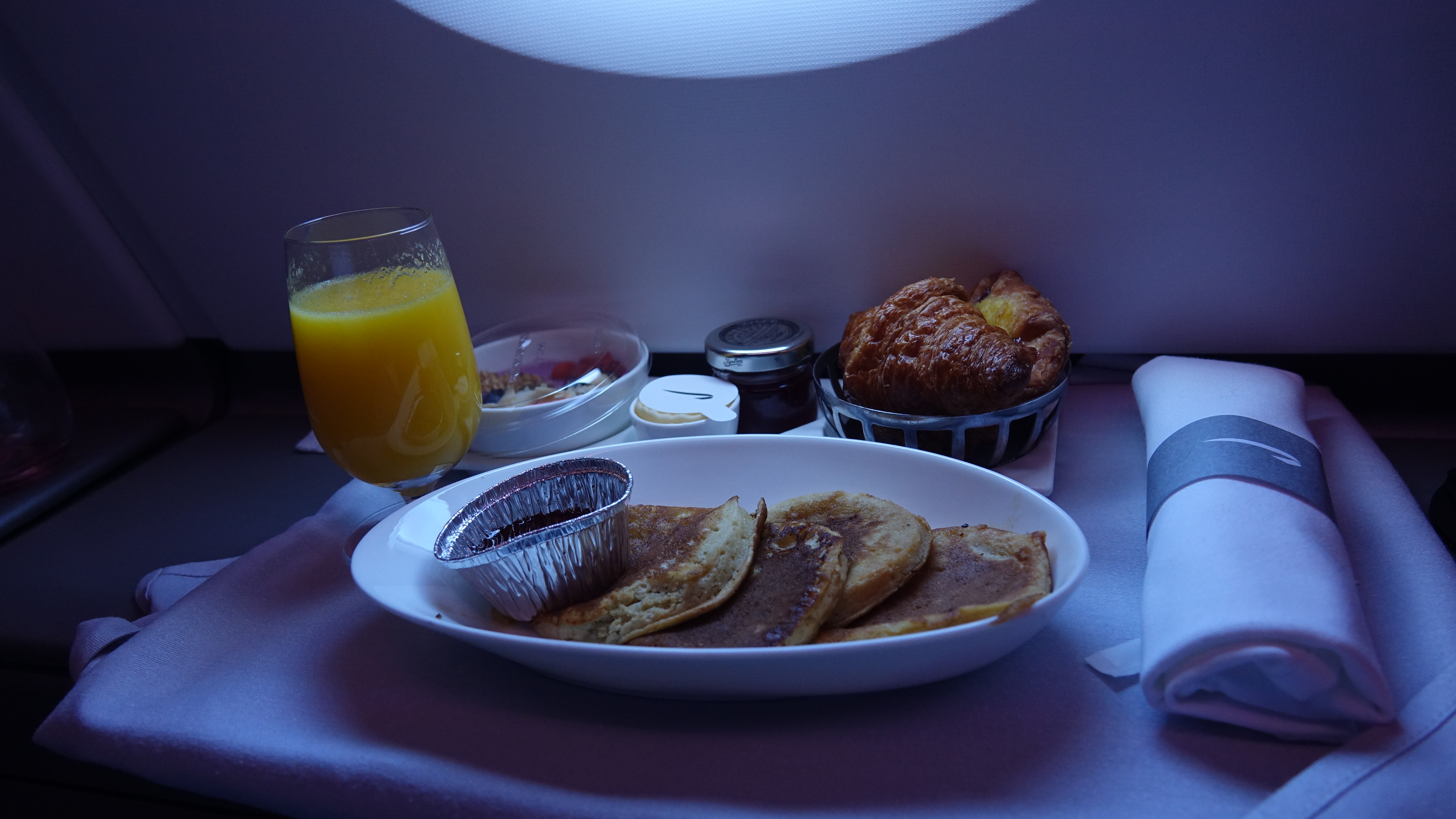 a plate of pancakes and a glass of juice