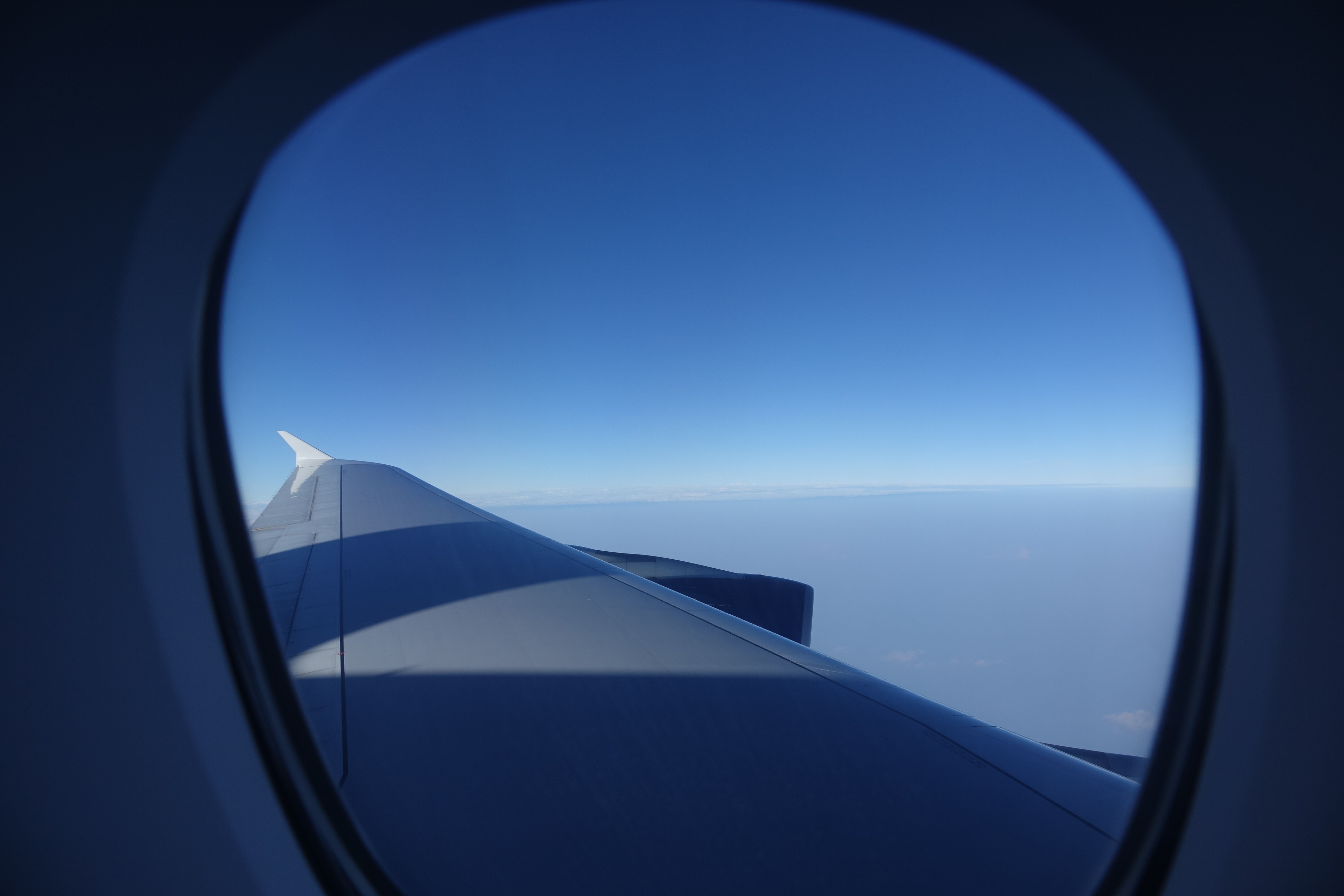 an airplane wing and blue sky