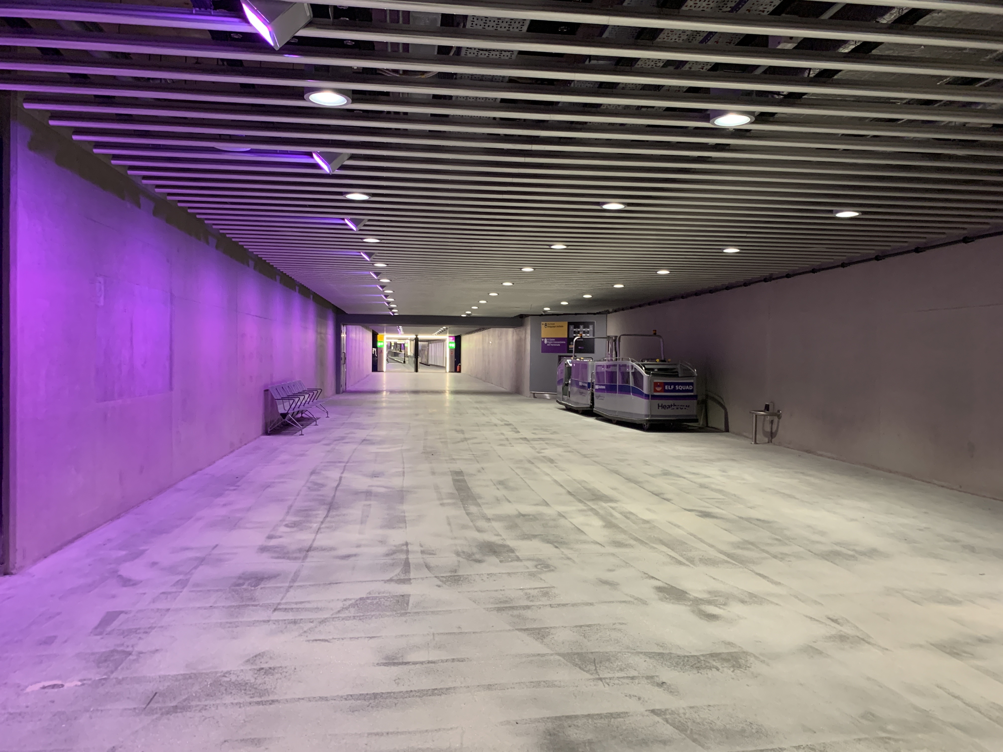 a long hallway with purple lights