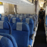 a row of blue and white seats on an airplane