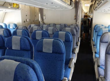a row of blue and white seats on an airplane