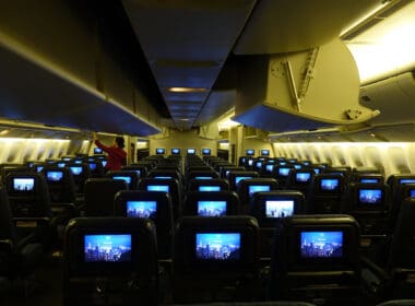 a row of seats with rows of televisions