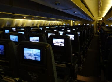 rows of seats with monitors on them