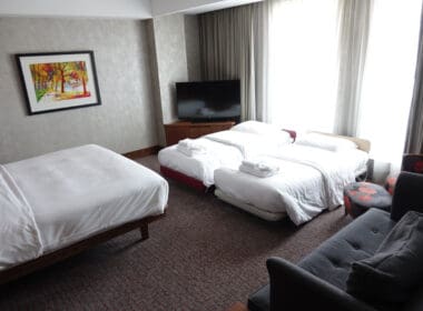 a room with beds and a television