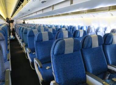 a row of blue seats on an airplane