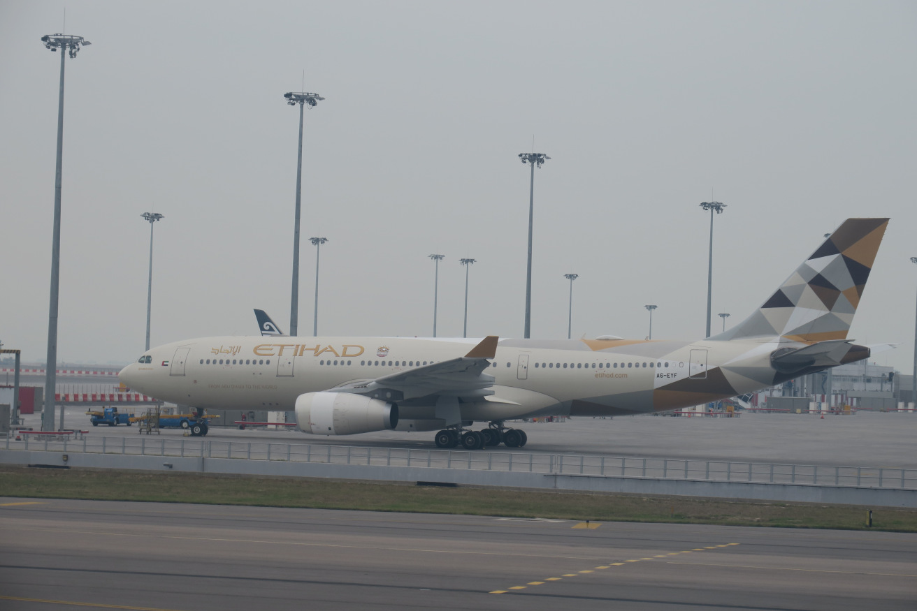 a large white airplane on a runway