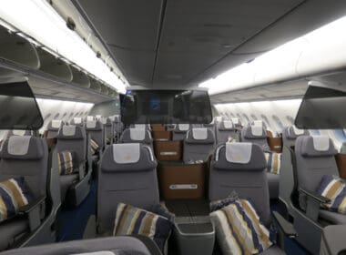 the inside of an airplane with seats and a television