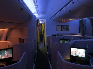 a row of seats with tvs on the side